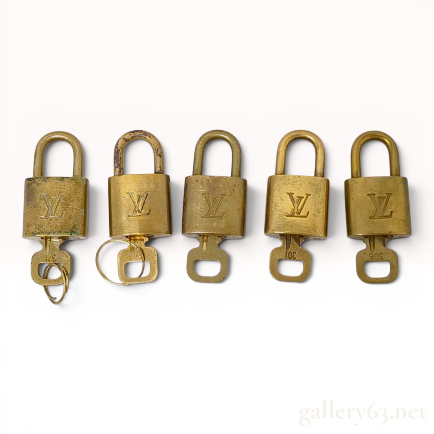 A Collection of Louis Vuitton Brass Padlocks and Keys