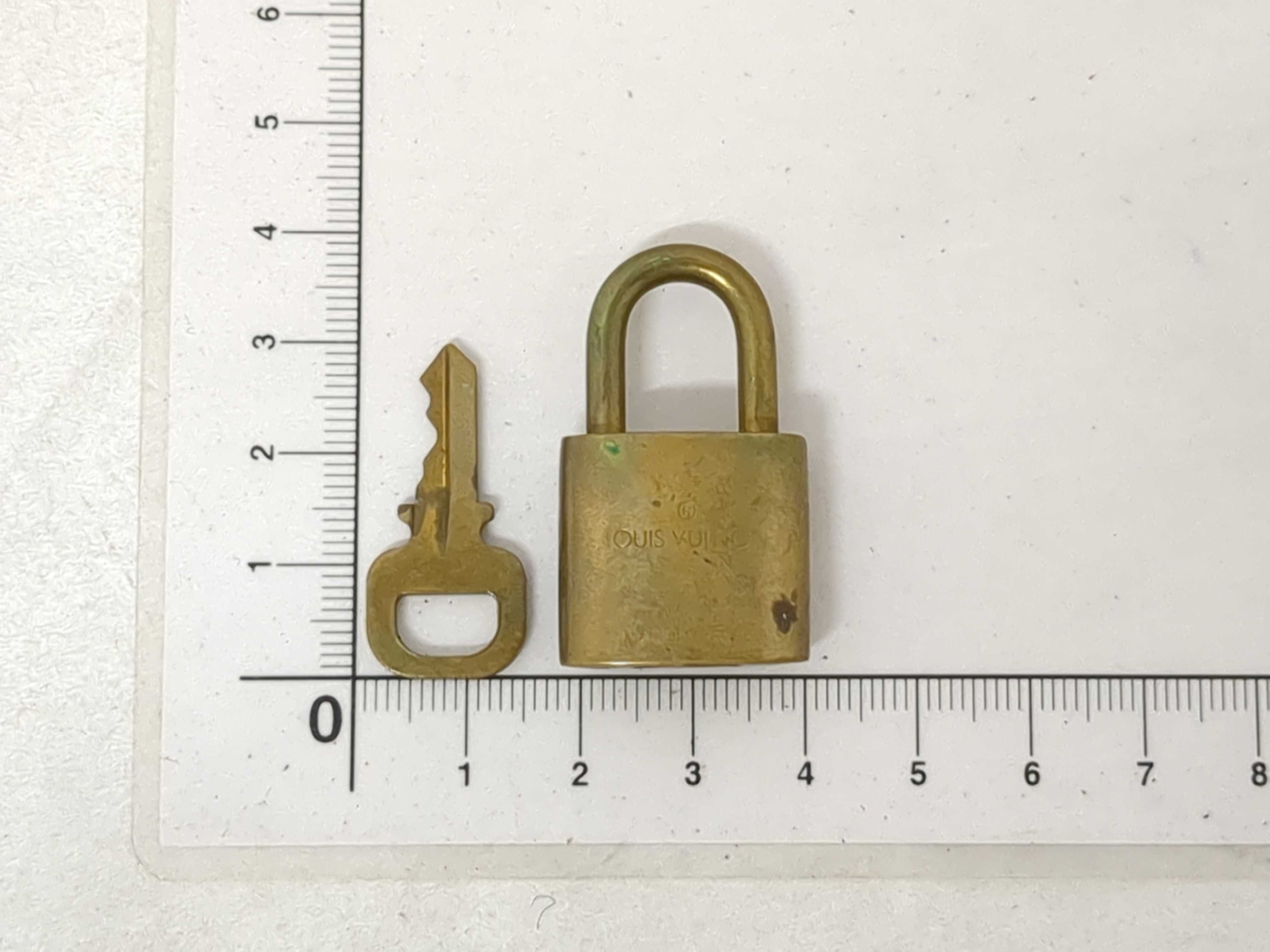 A Collection of Louis Vuitton Brass Padlocks and Keys