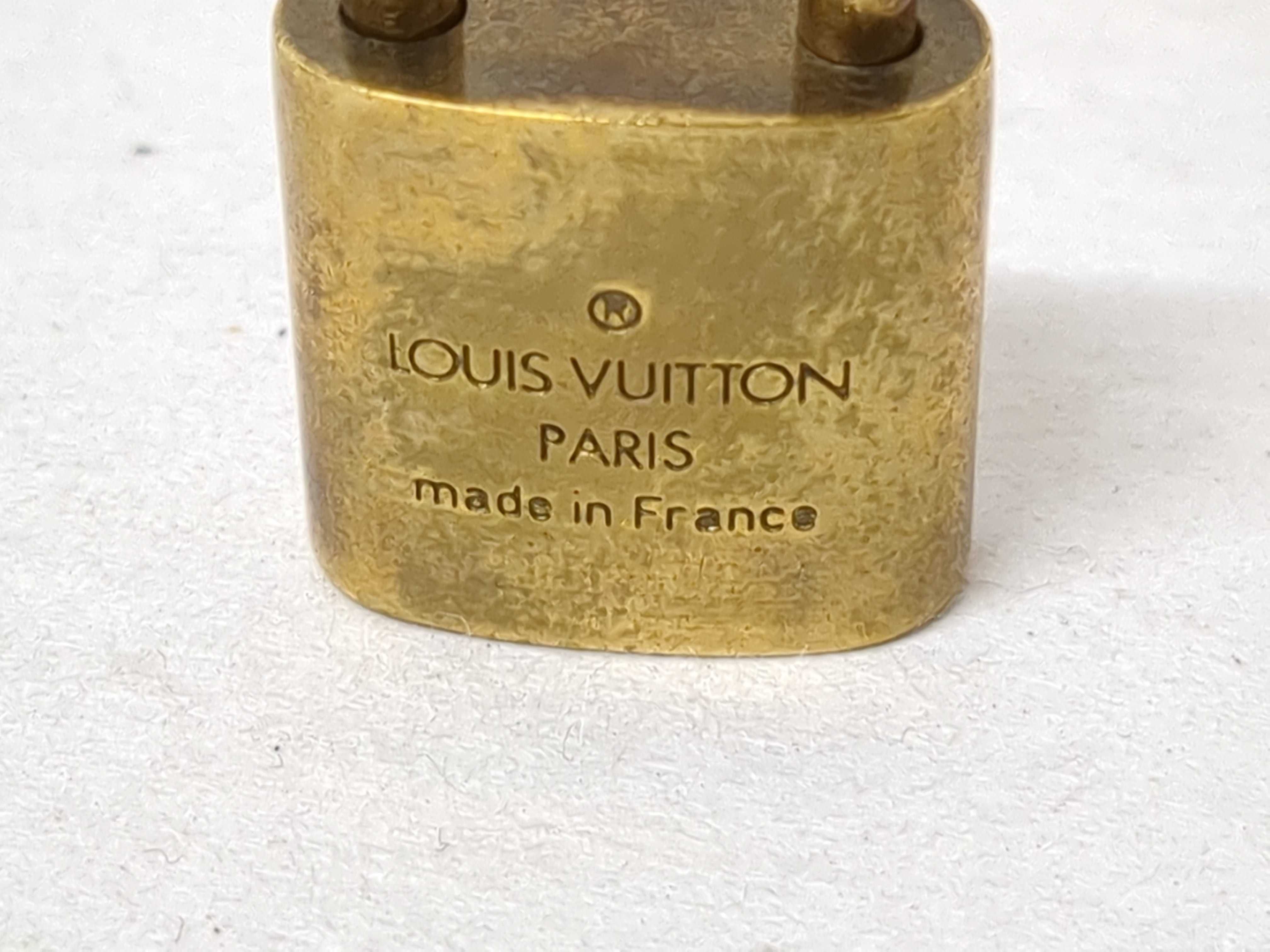 A Collection of Louis Vuitton Brass Padlocks and Keys