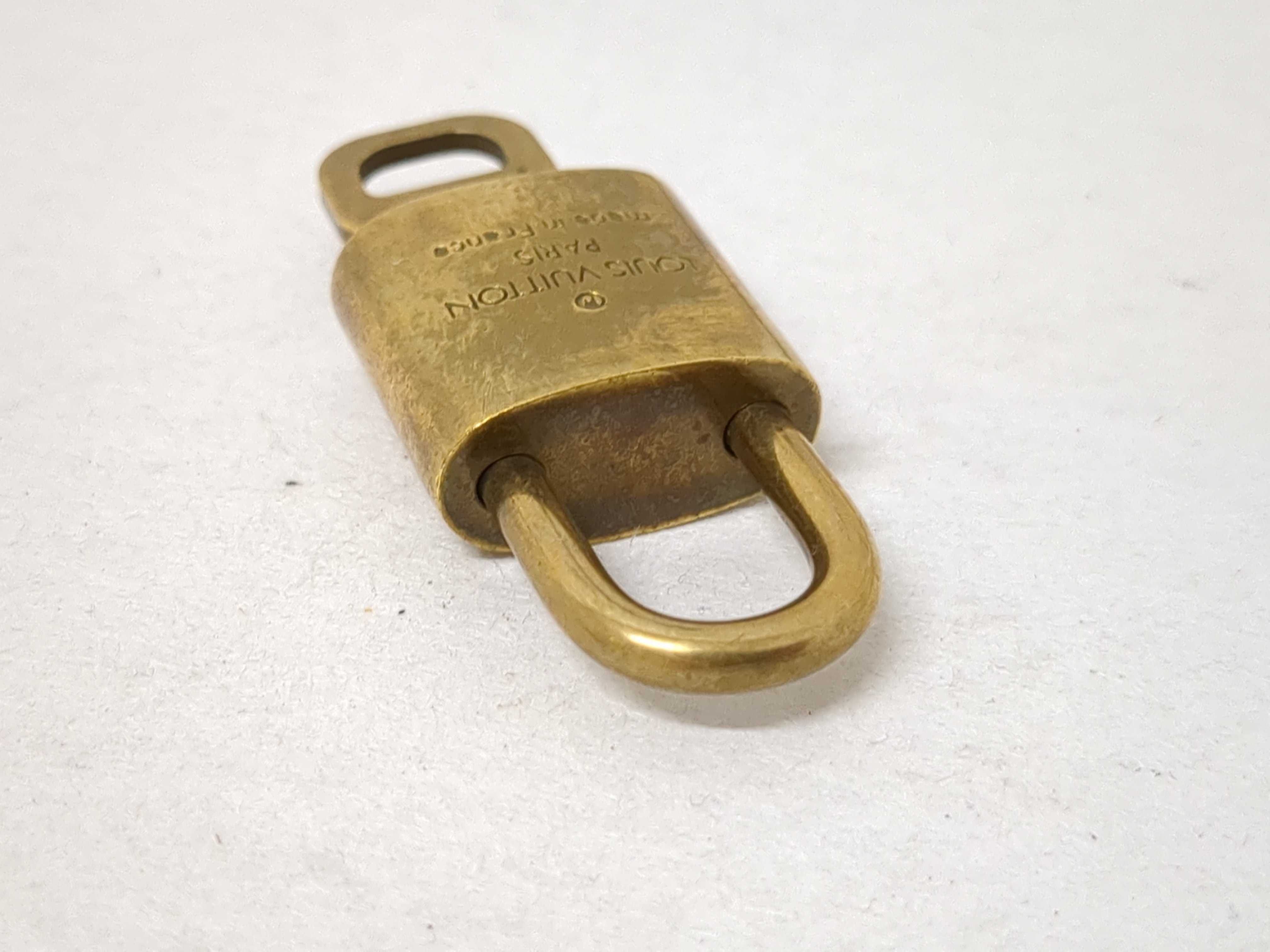 A Collection of Louis Vuitton Brass Padlocks and Keys