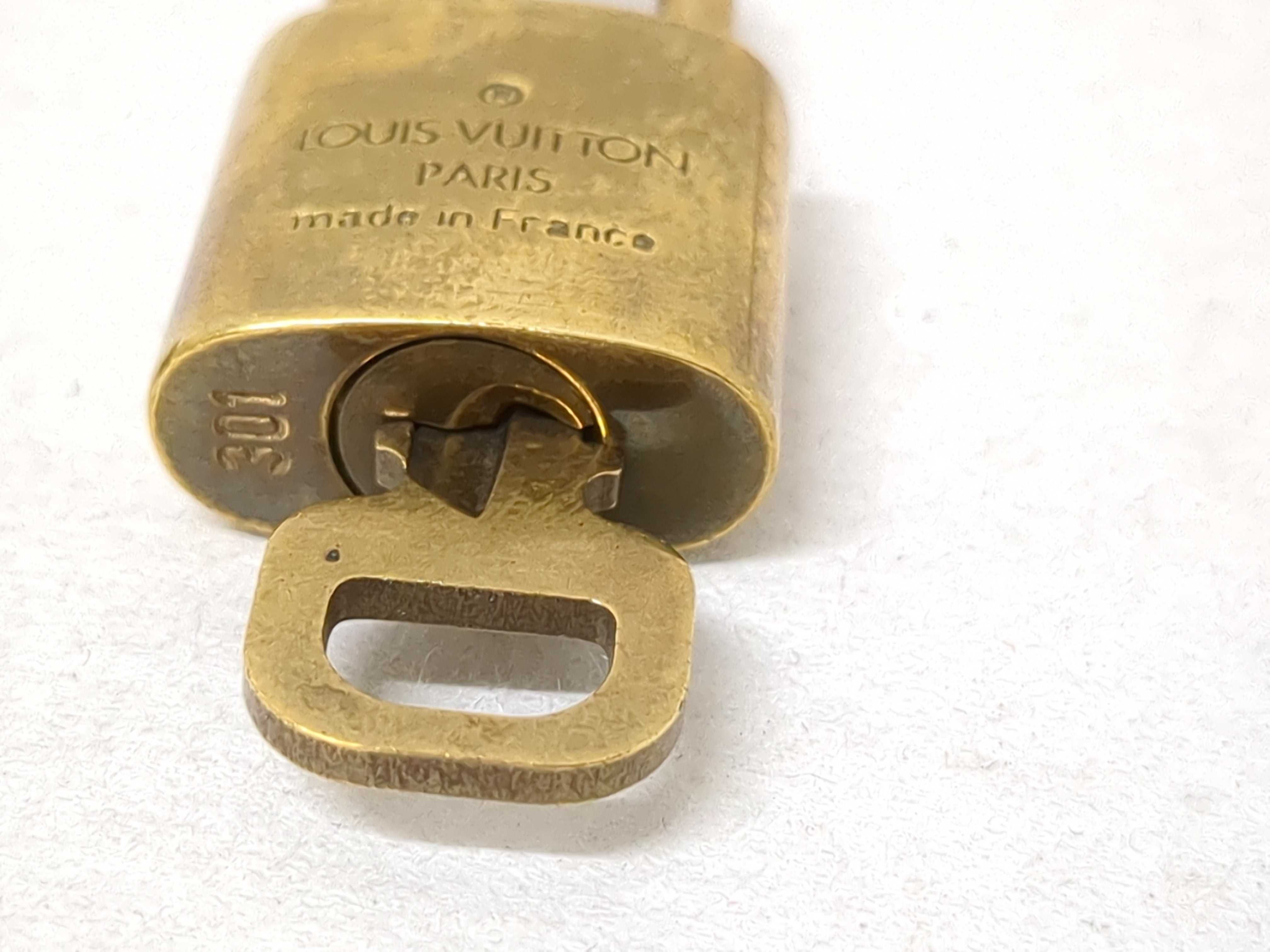 A Collection of Louis Vuitton Brass Padlocks and Keys