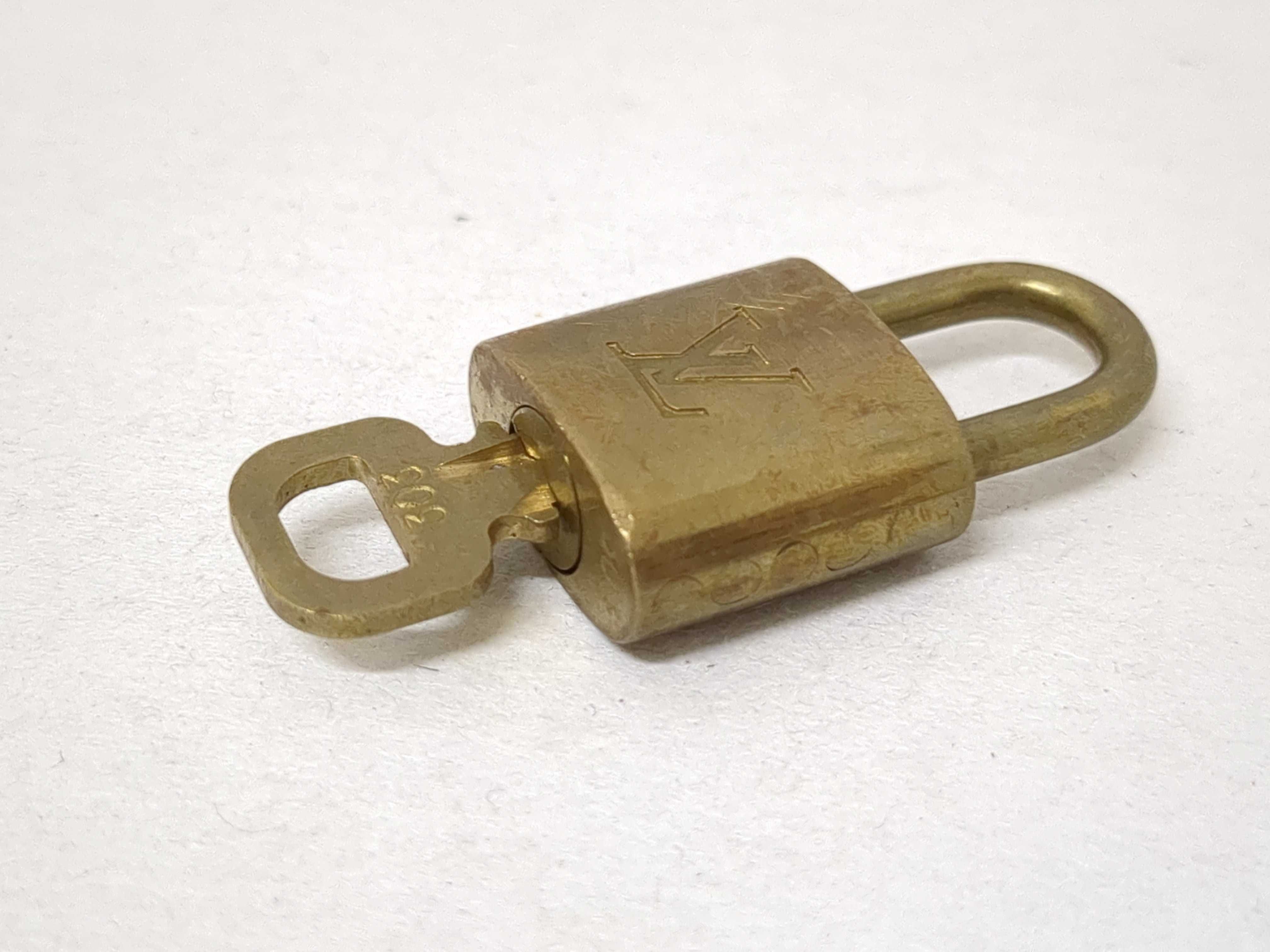 A Collection of Louis Vuitton Brass Padlocks and Keys