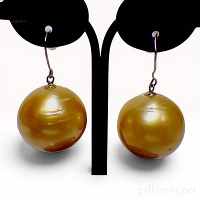 A Pair of Semi-Round Golden Pearl and Pt900 Platinum Earrings. This pair of drop earrings 