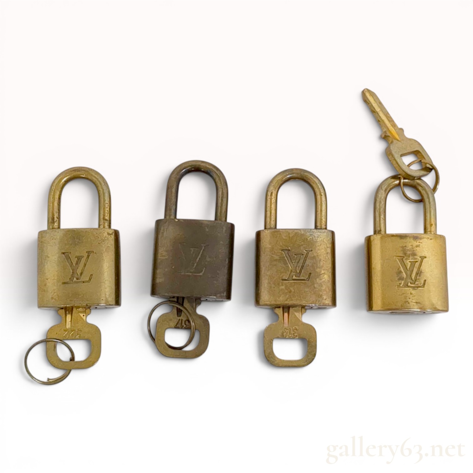 A Set of Four Louis Vuitton Brass Padlocks with Matching Keys