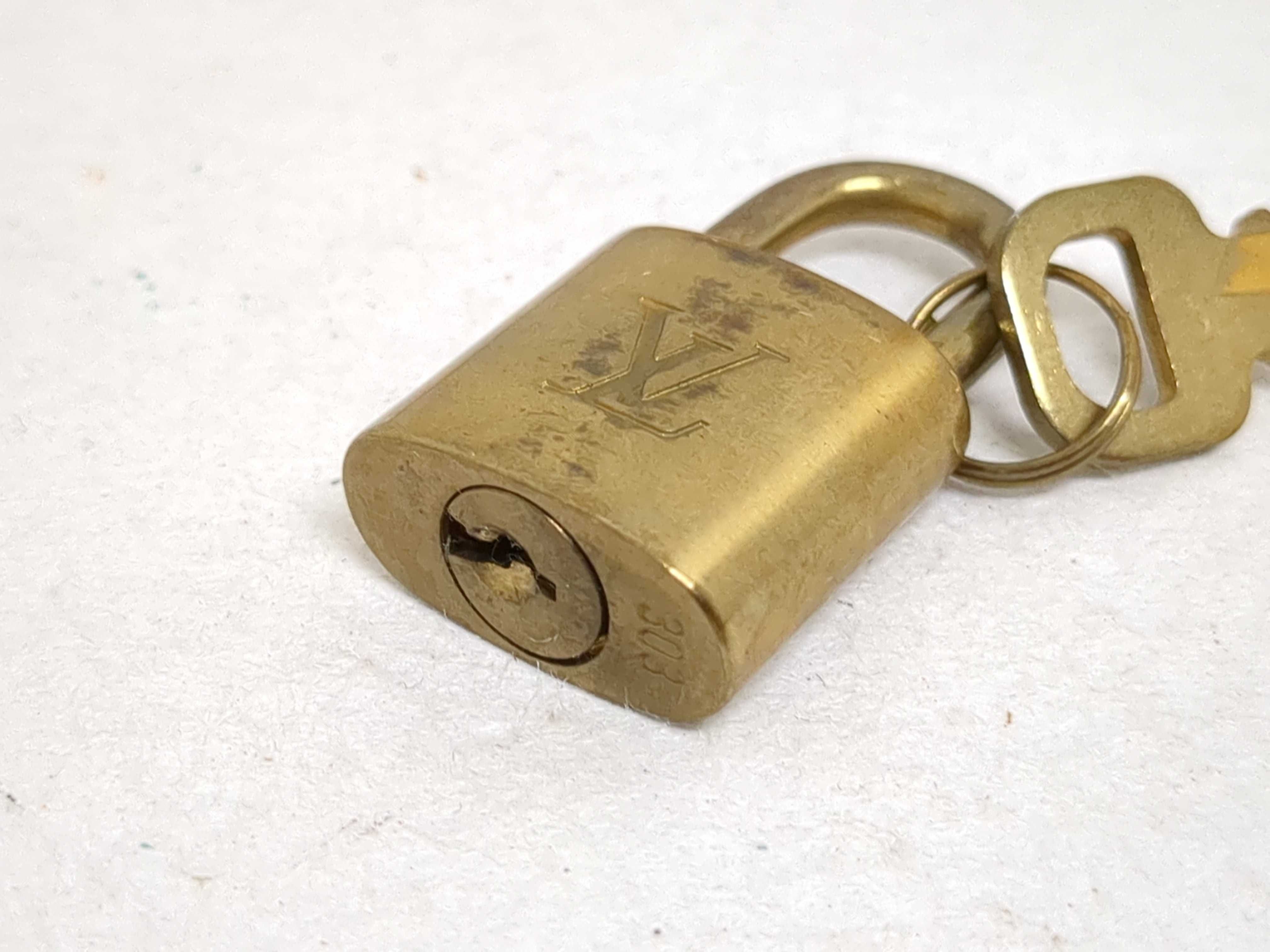 A Set of Four Louis Vuitton Brass Padlocks with Matching Keys