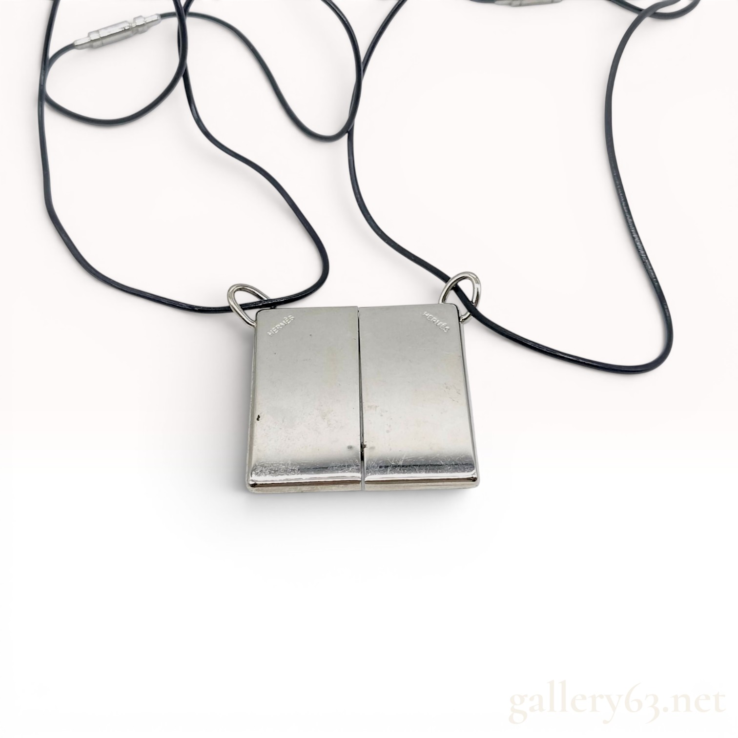 A Pair of Hermes Symbole 1+1=1 Interlocking Pendant Necklaces