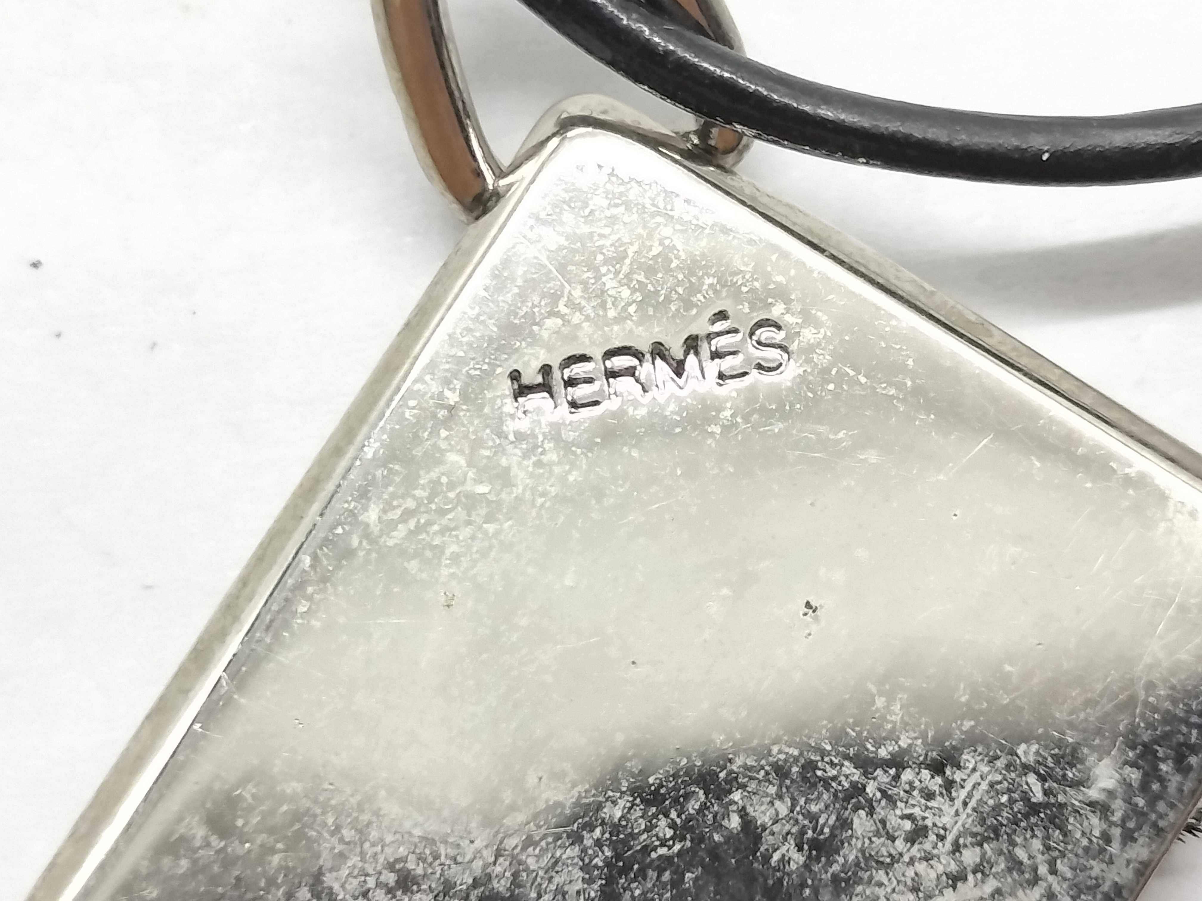A Pair of Hermes Symbole 1+1=1 Interlocking Pendant Necklaces