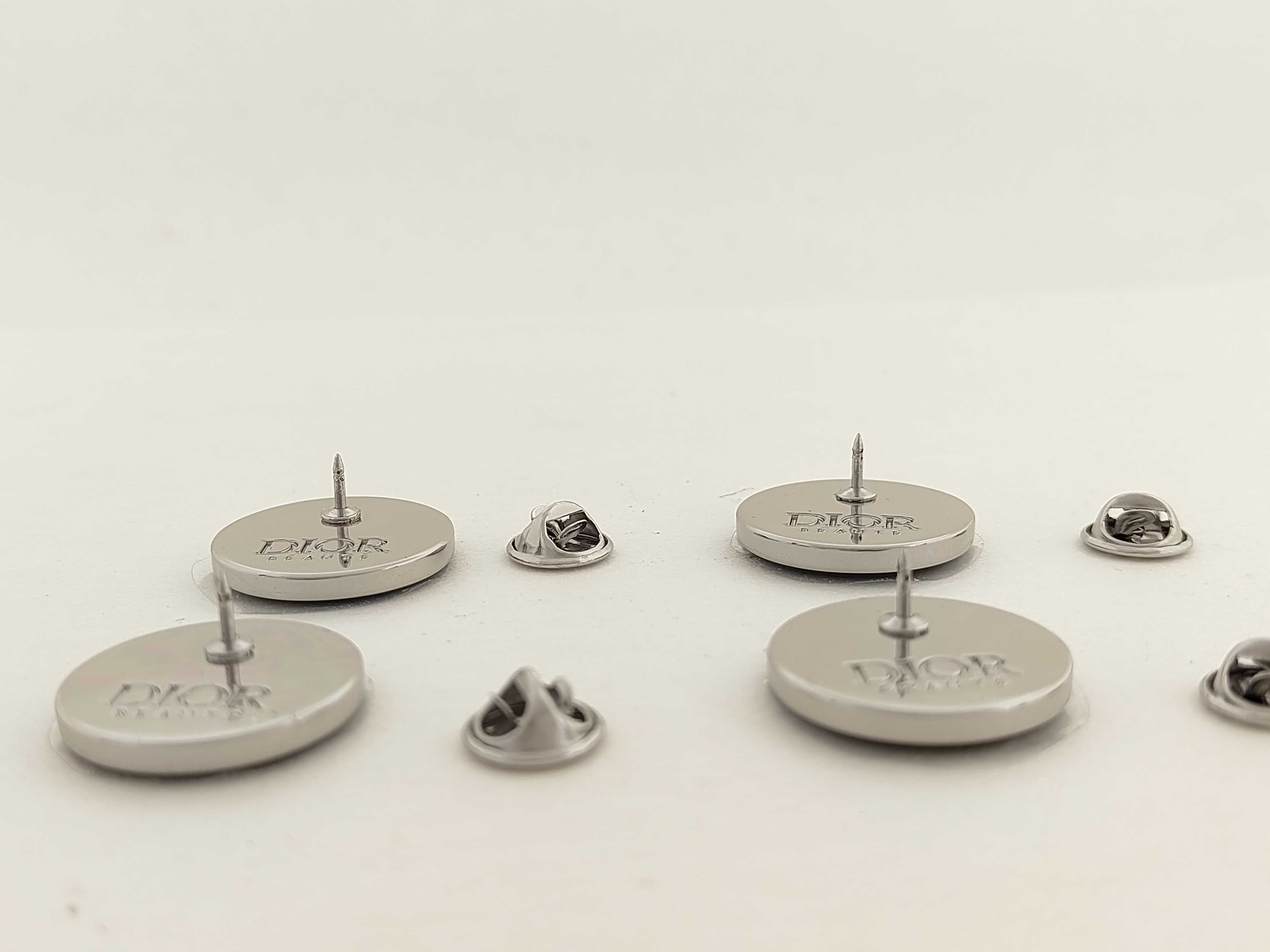 A Set of Four Dior Beaute Novelty Circular Lapel Pins