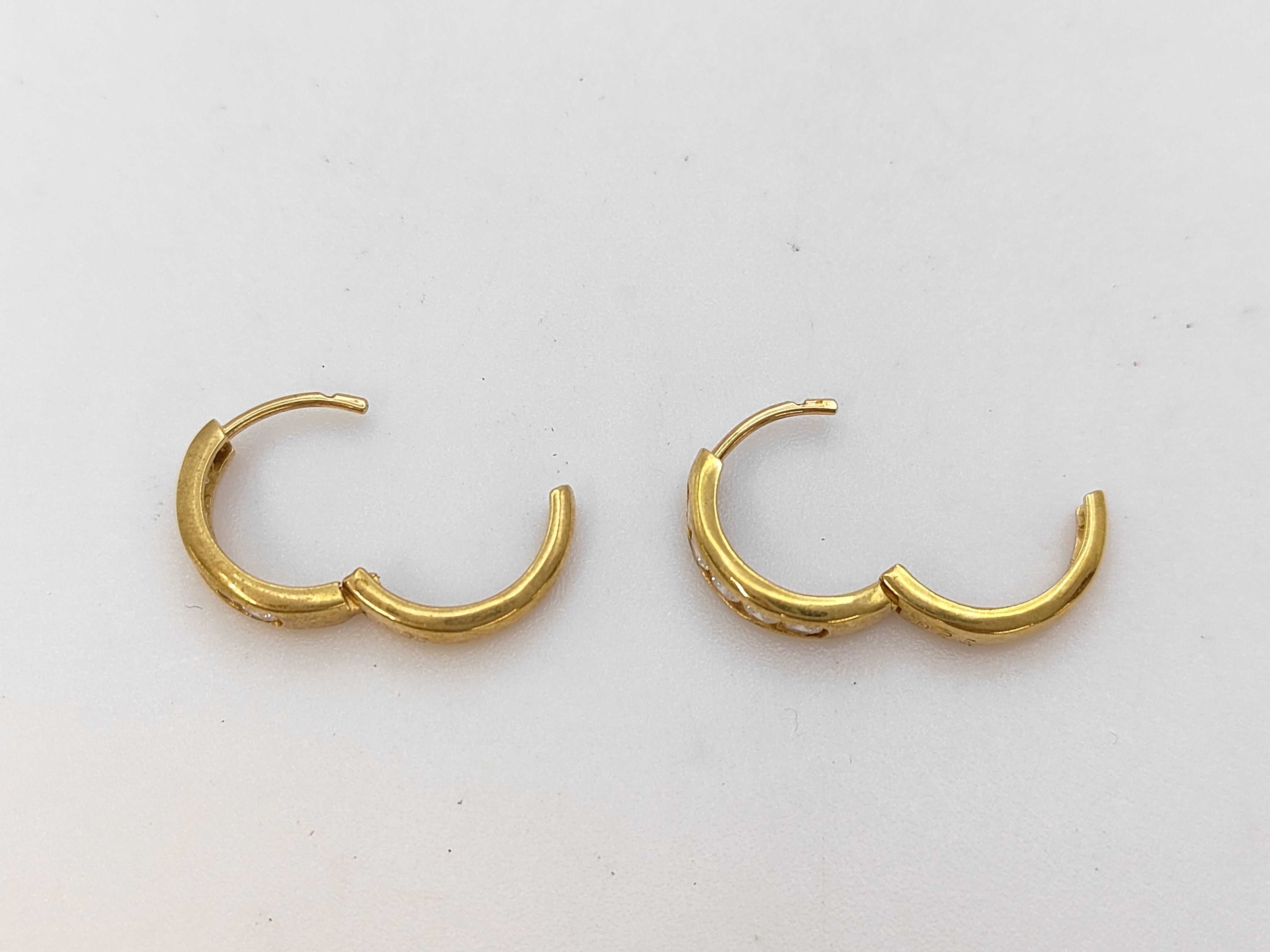 A Pair of 18 Karat Yellow Gold and Diamond Channel-Set Huggie Hoop Earrings