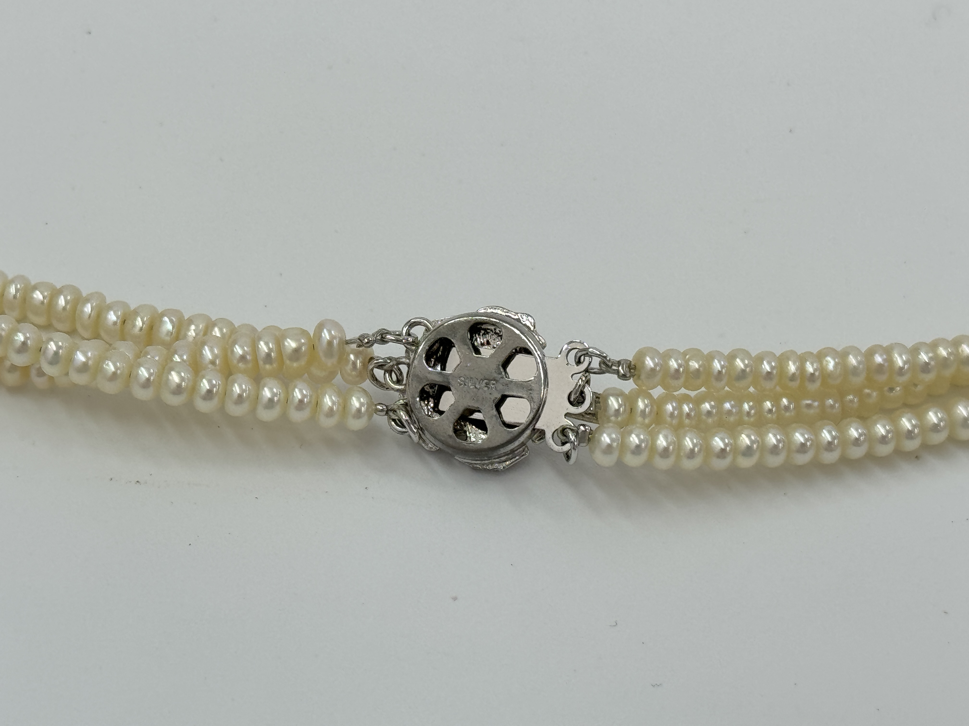 Triple Strand Semi-Round Pearl Necklace with Silver Floral Clasp