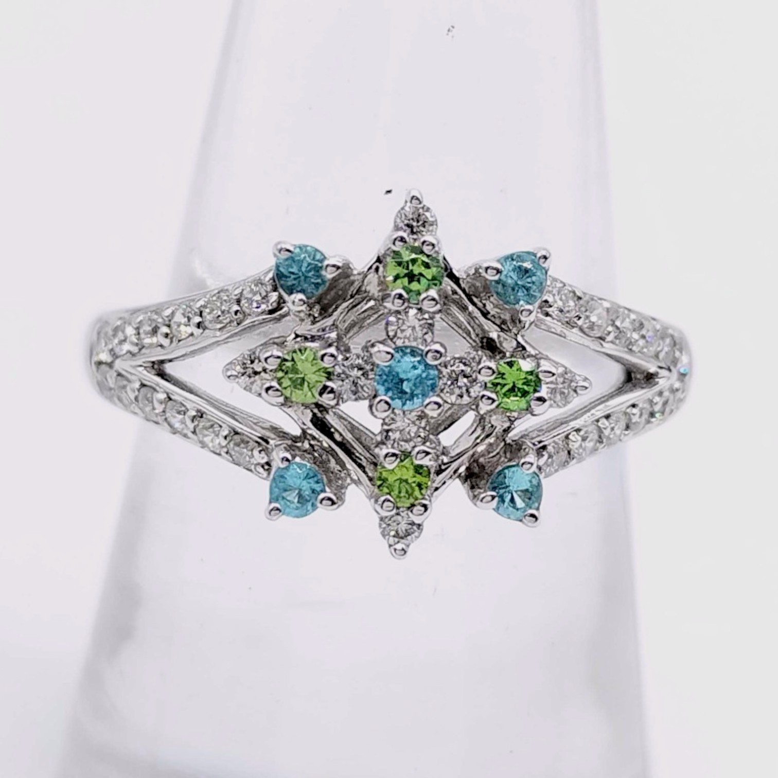 An 18 Karat White Gold Paraiba Tourmaline, Demantoid Garnet, and Diamond Starburst Ring