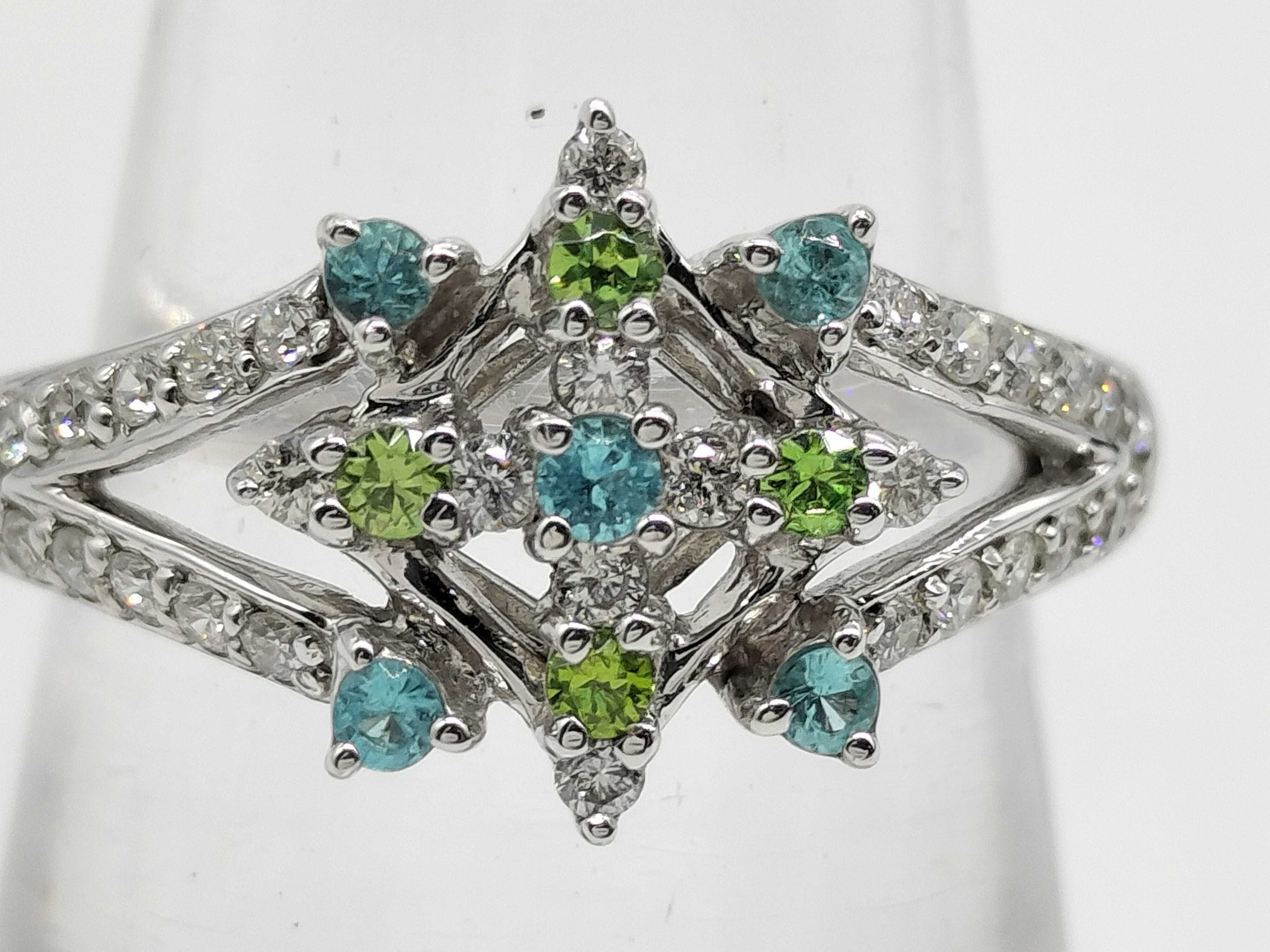 An 18 Karat White Gold Paraiba Tourmaline, Demantoid Garnet, and Diamond Starburst Ring