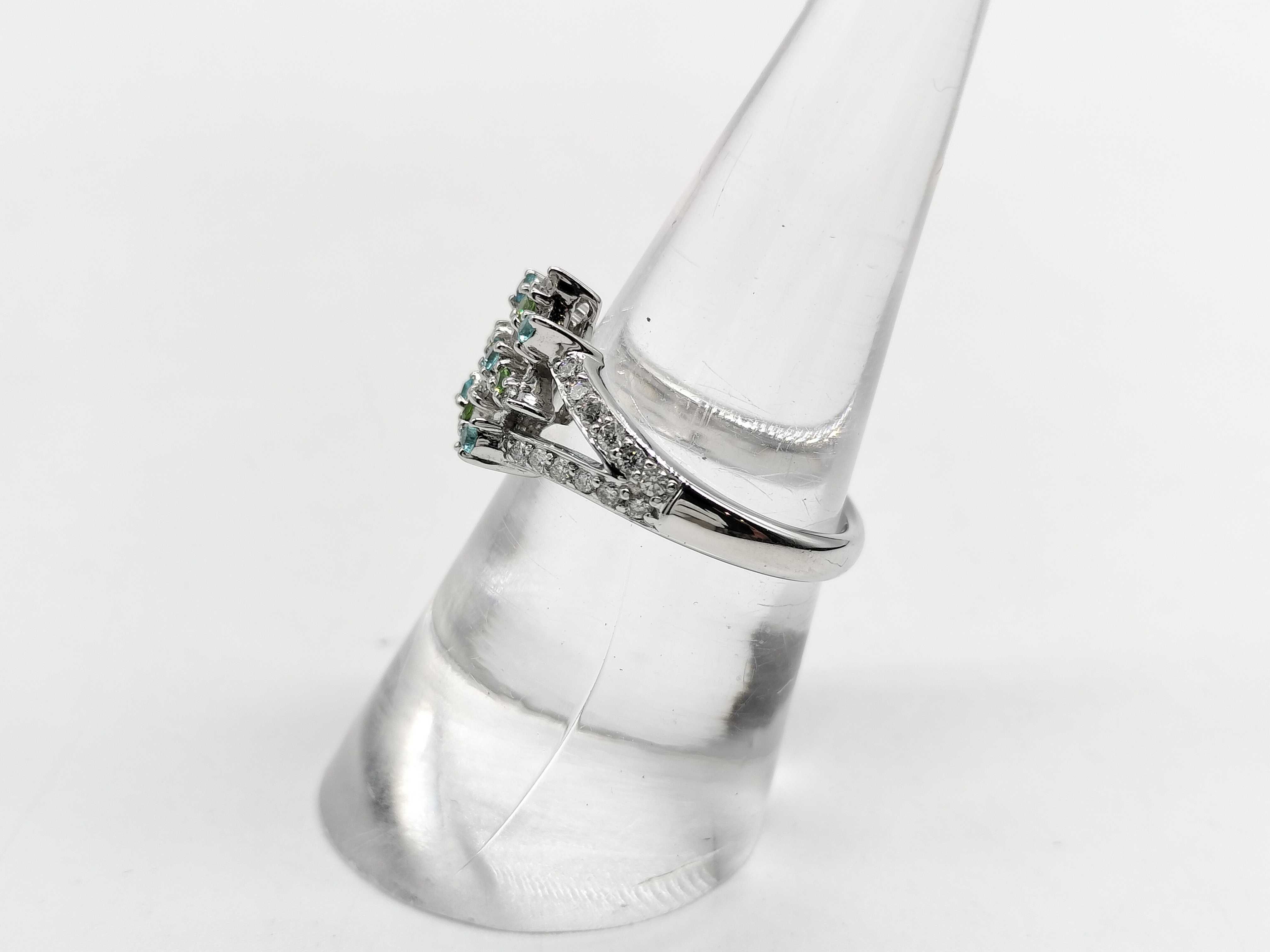 An 18 Karat White Gold Paraiba Tourmaline, Demantoid Garnet, and Diamond Starburst Ring