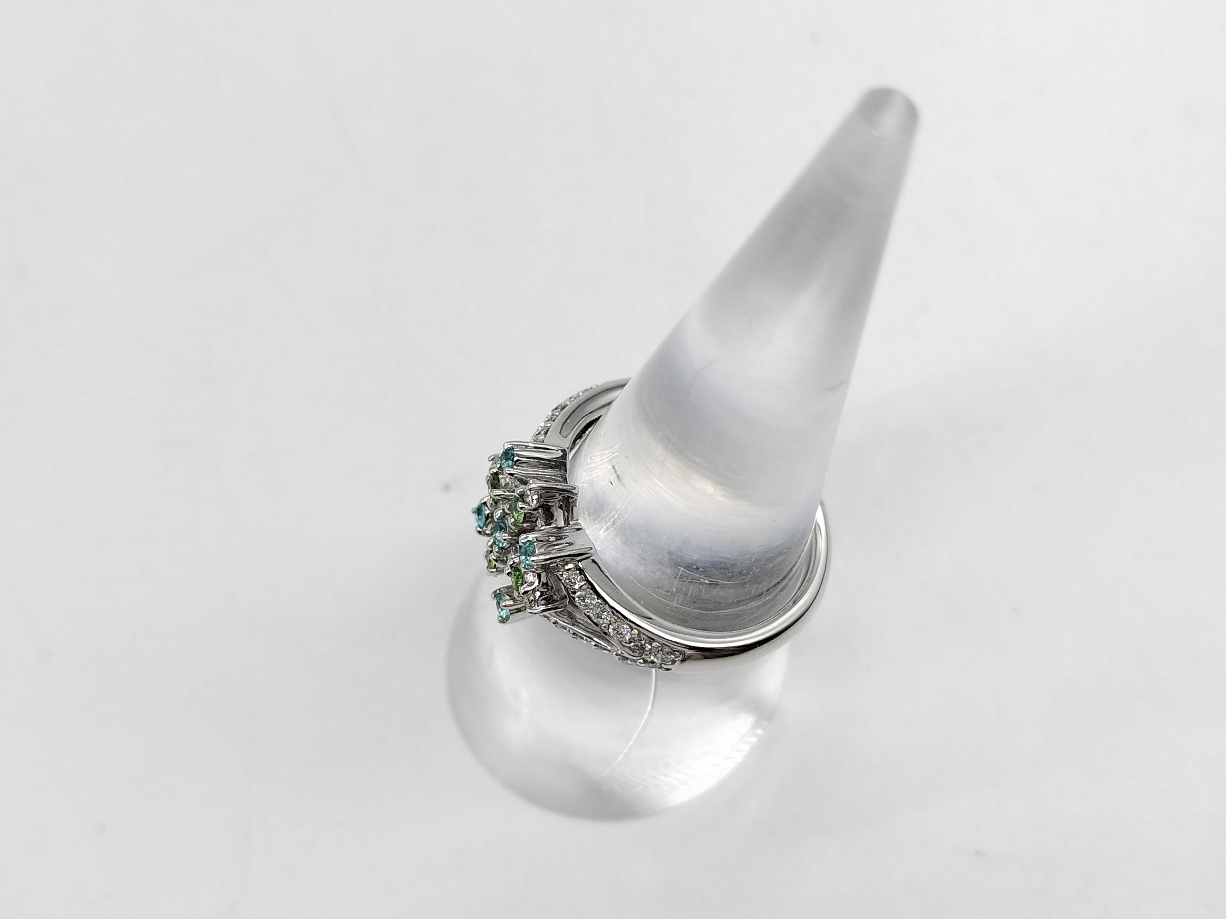An 18 Karat White Gold Paraiba Tourmaline, Demantoid Garnet, and Diamond Starburst Ring
