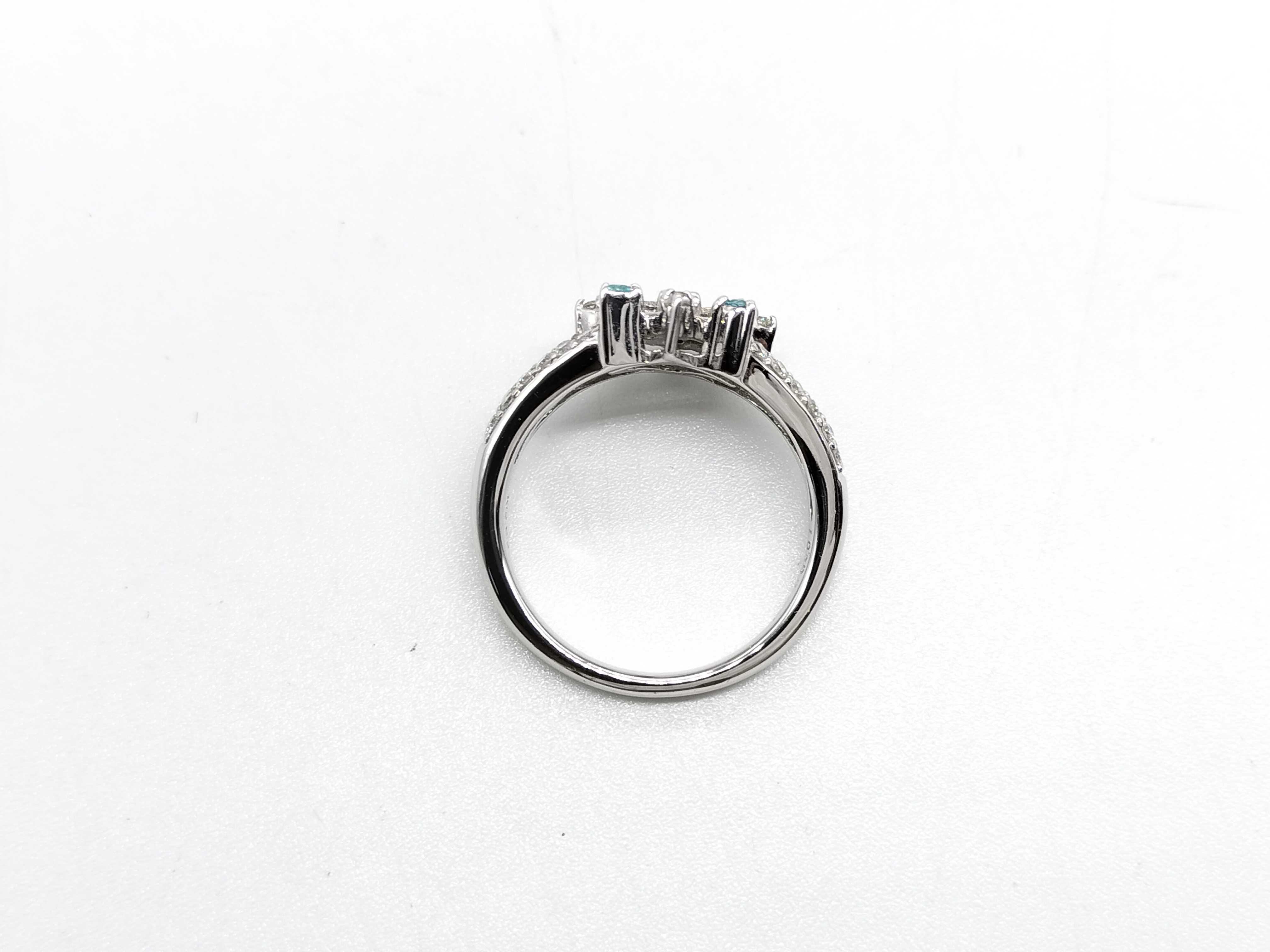 An 18 Karat White Gold Paraiba Tourmaline, Demantoid Garnet, and Diamond Starburst Ring
