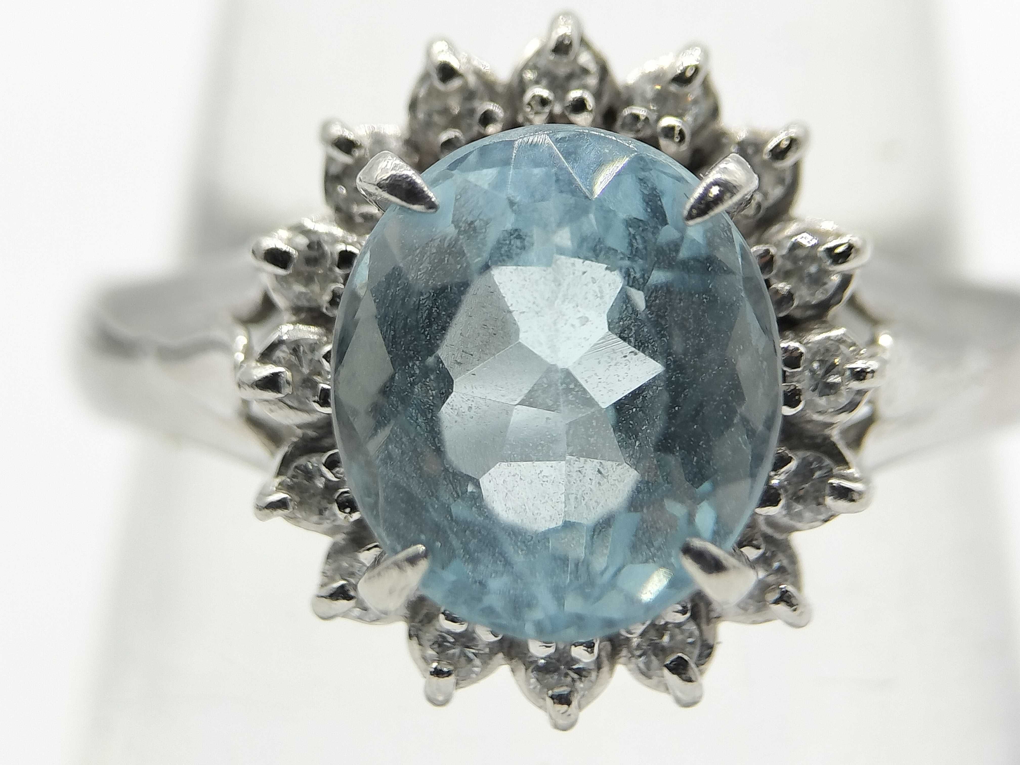 An Aquamarine and Diamond Halo Ring in Platinum