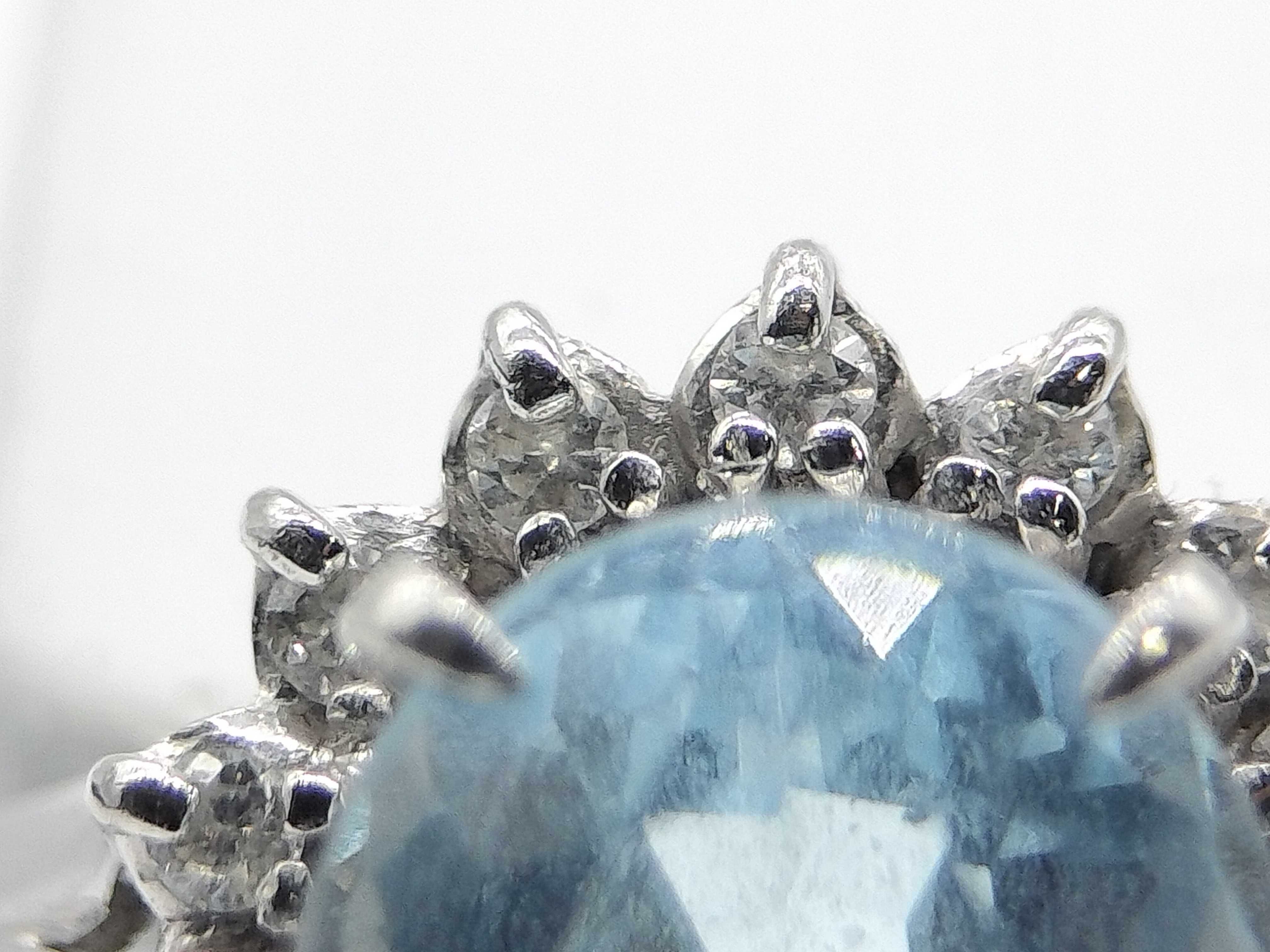 An Aquamarine and Diamond Halo Ring in Platinum