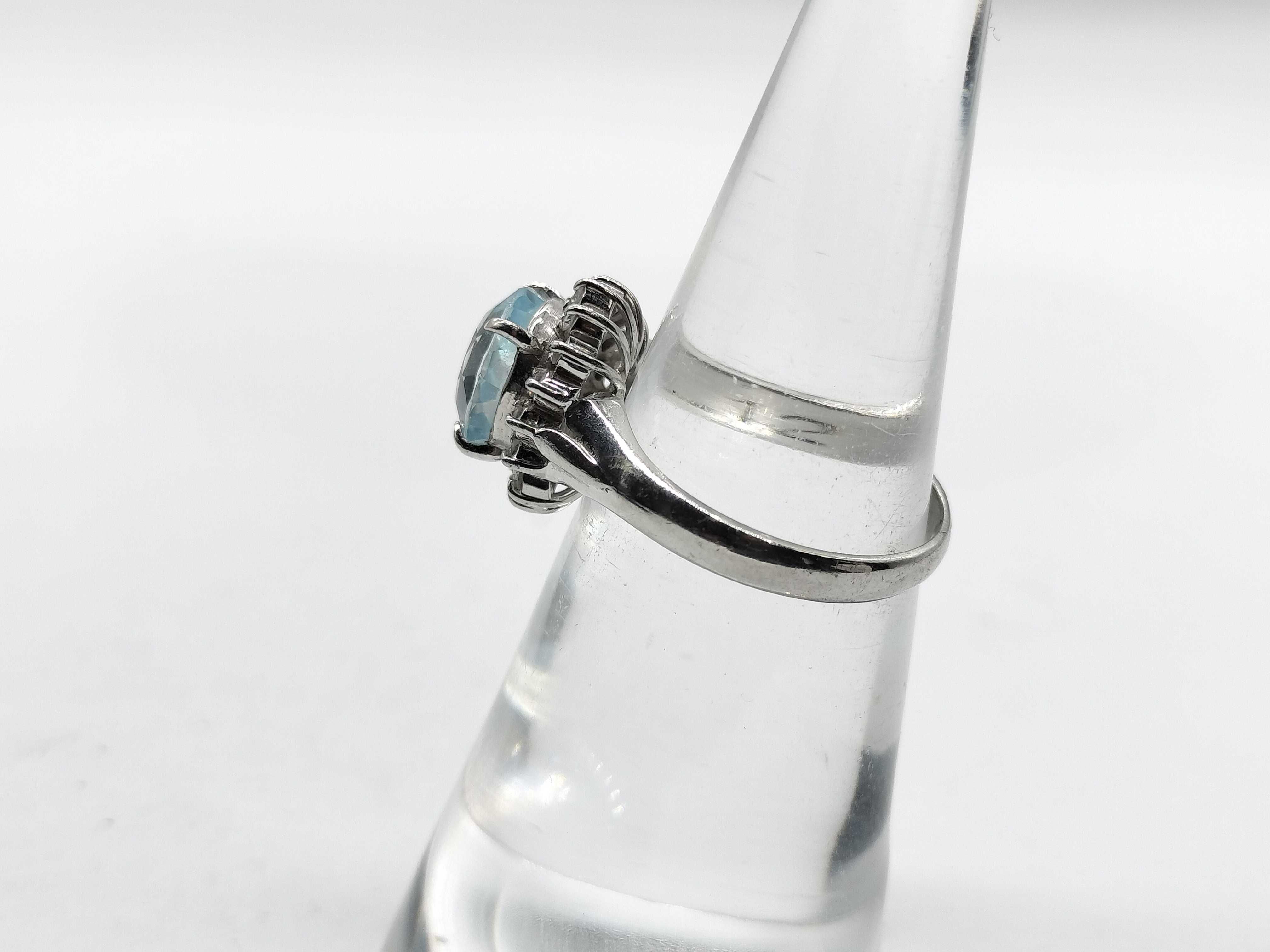 An Aquamarine and Diamond Halo Ring in Platinum