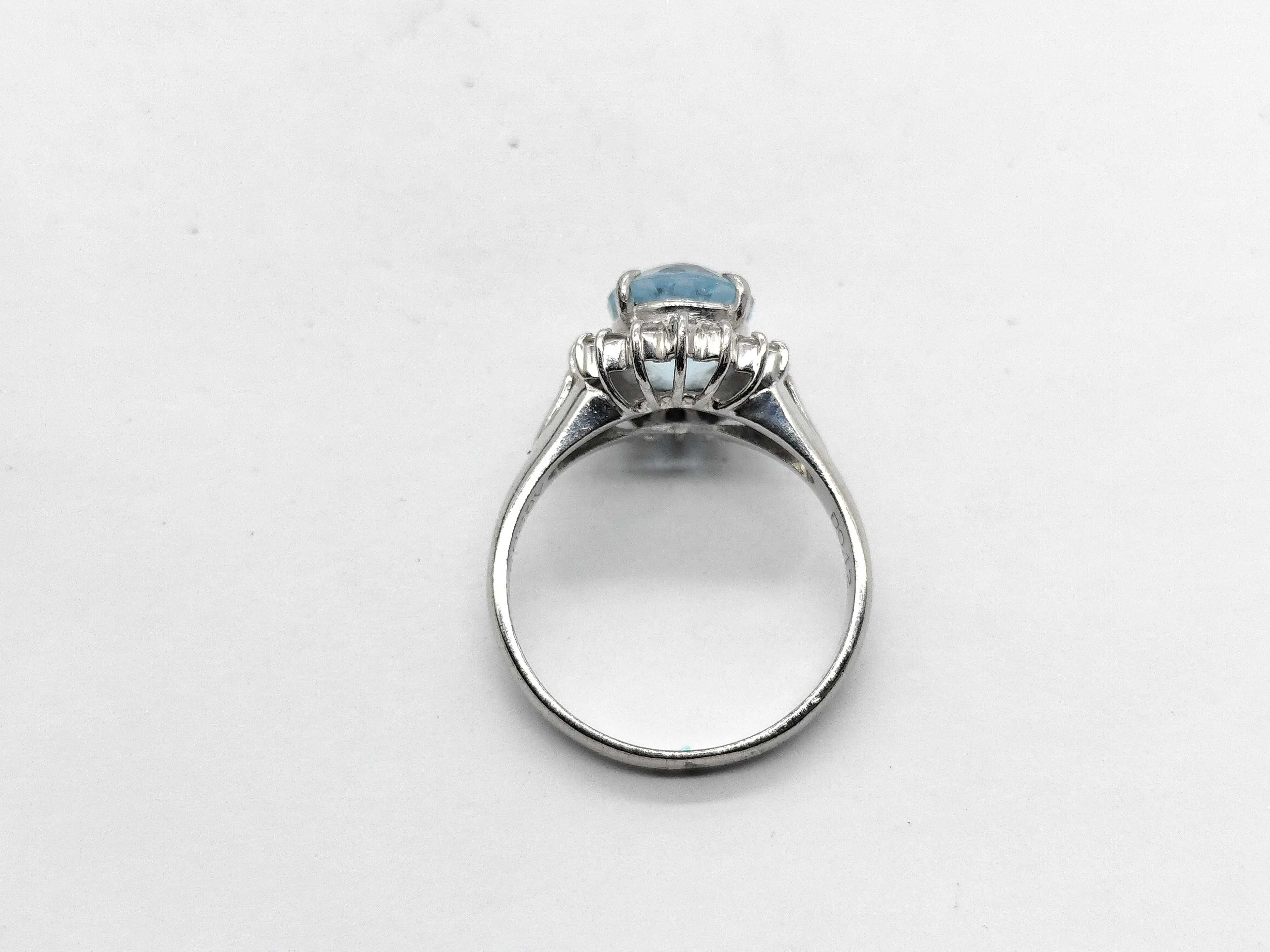 An Aquamarine and Diamond Halo Ring in Platinum