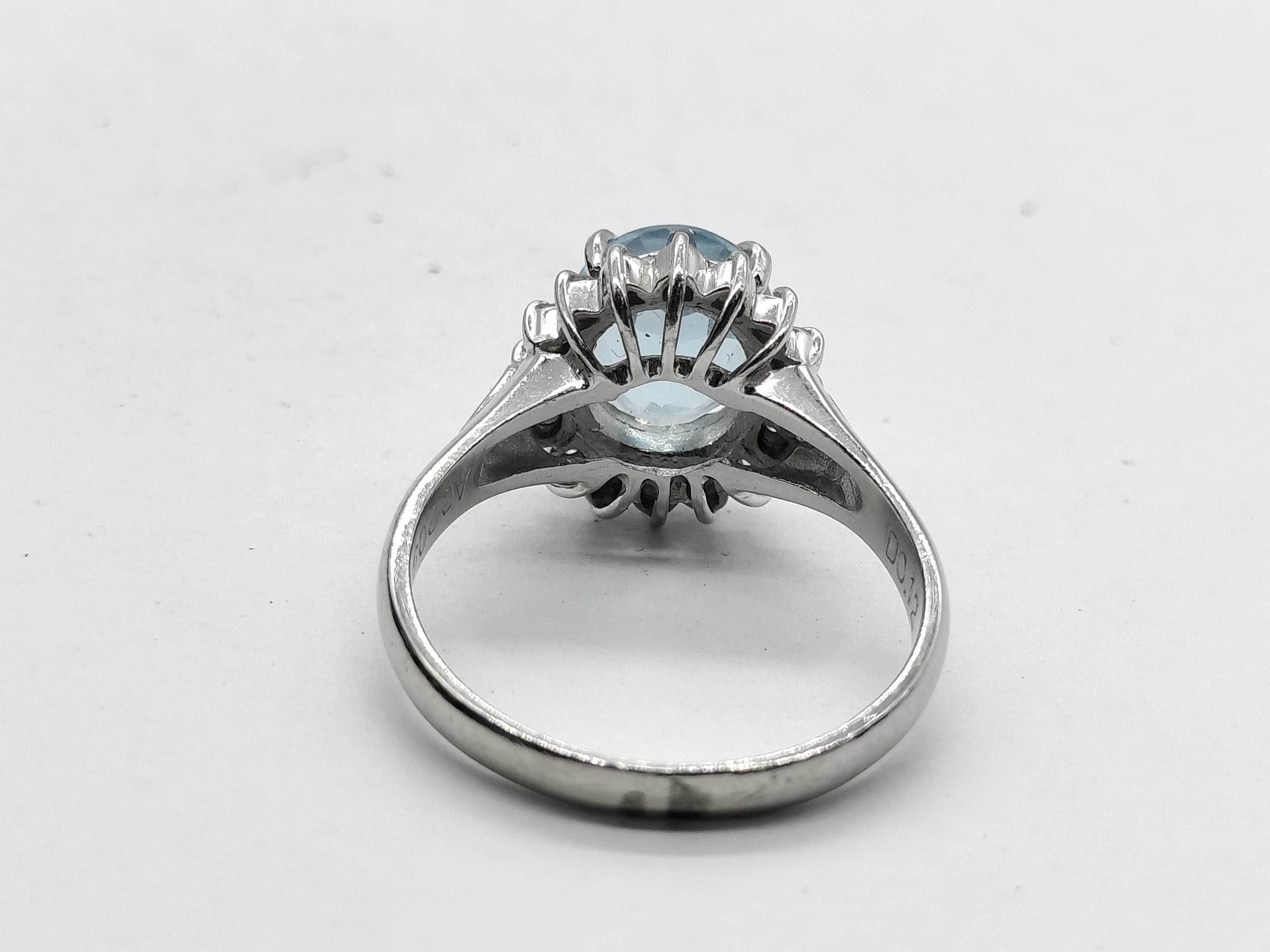 An Aquamarine and Diamond Halo Ring in Platinum