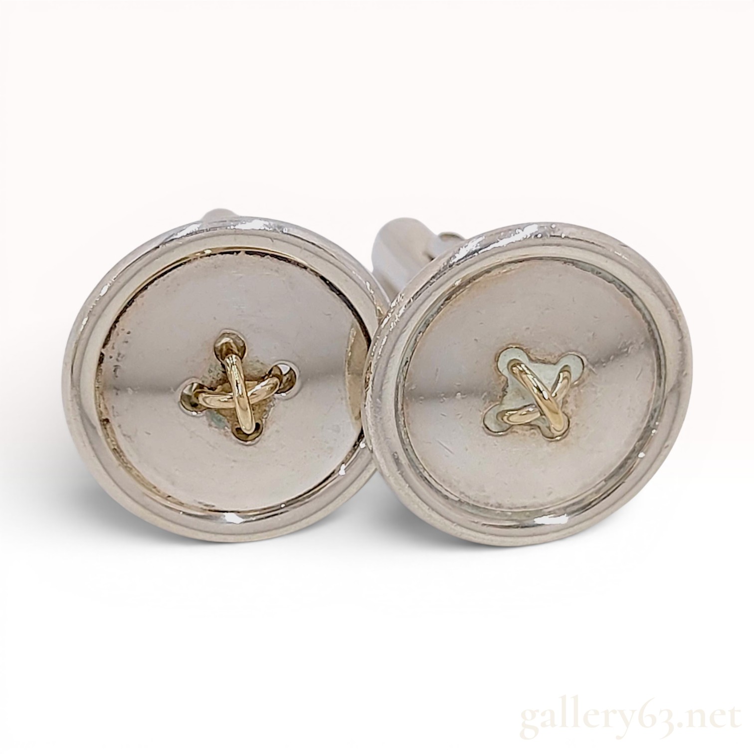 A Pair of Tiffany & Co. Sterling Silver and 18 Karat Yellow Gold Button-Motif Cufflinks