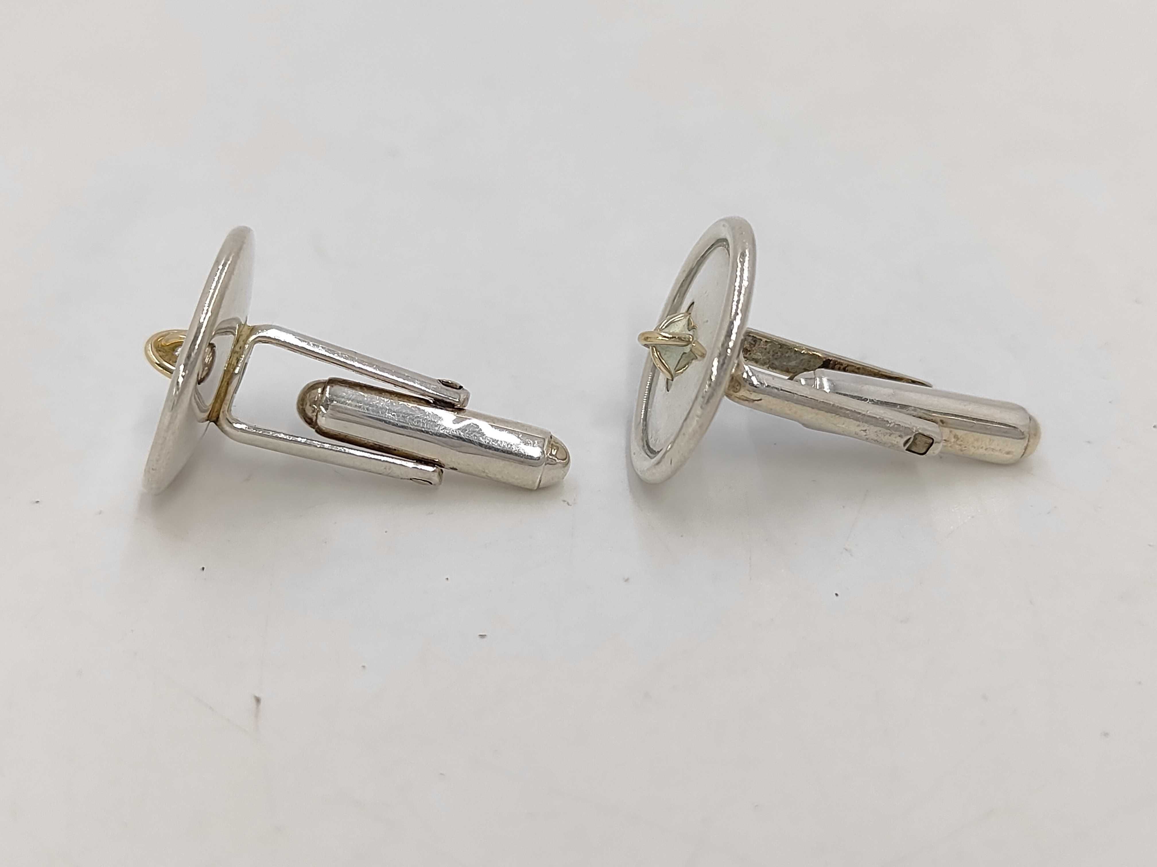 A Pair of Tiffany & Co. Sterling Silver and 18 Karat Yellow Gold Button-Motif Cufflinks