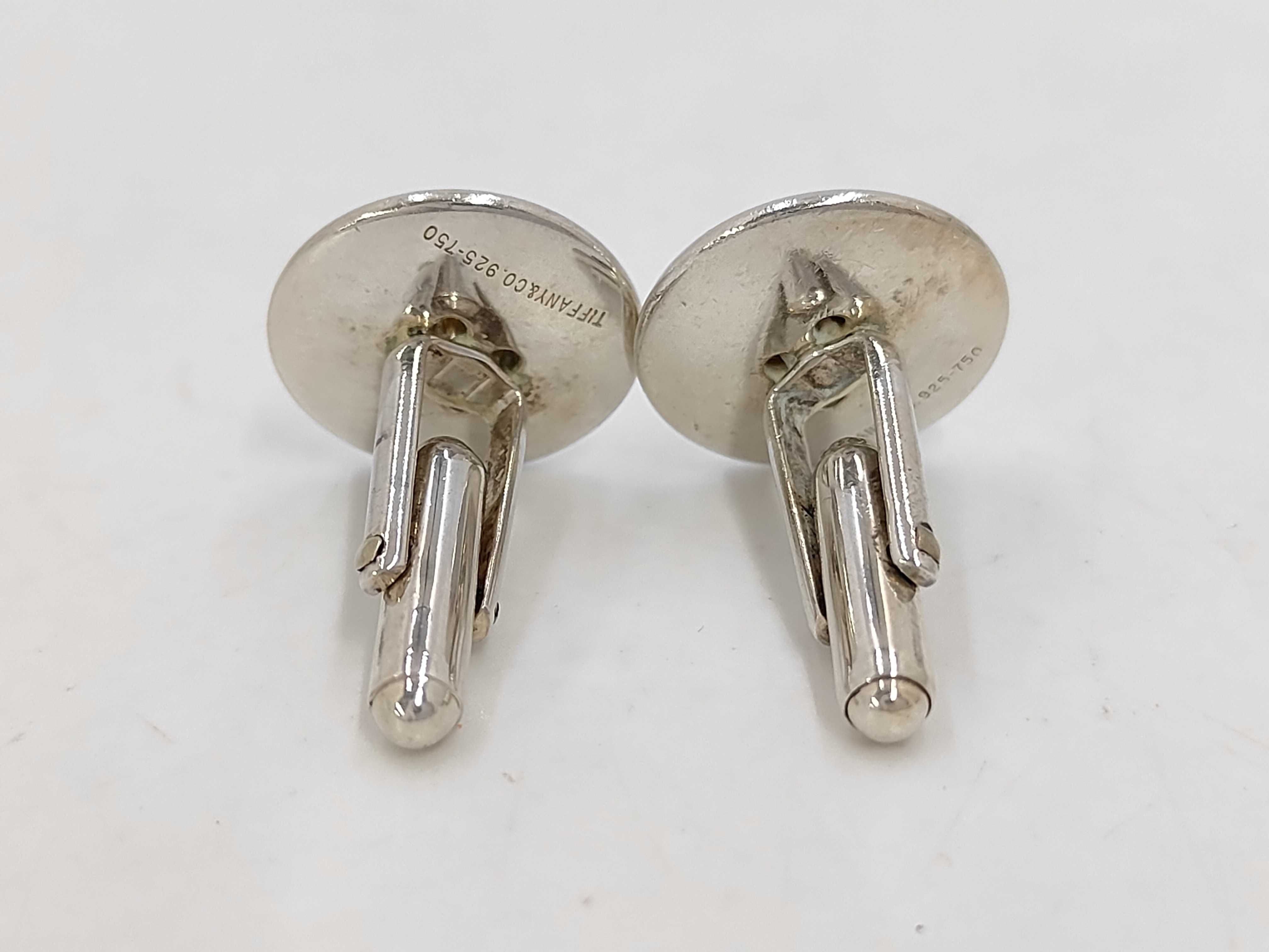 A Pair of Tiffany & Co. Sterling Silver and 18 Karat Yellow Gold Button-Motif Cufflinks