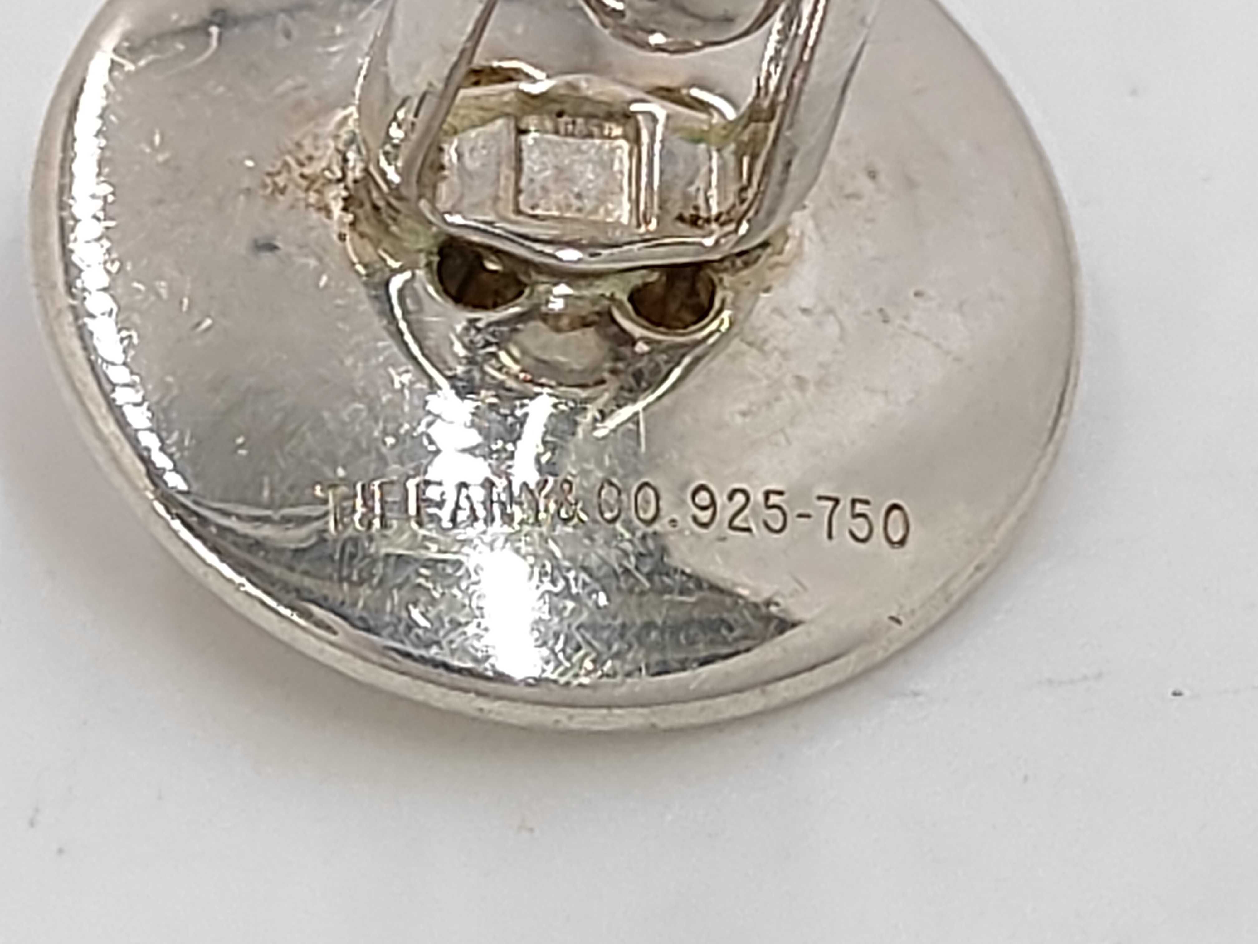 A Pair of Tiffany & Co. Sterling Silver and 18 Karat Yellow Gold Button-Motif Cufflinks