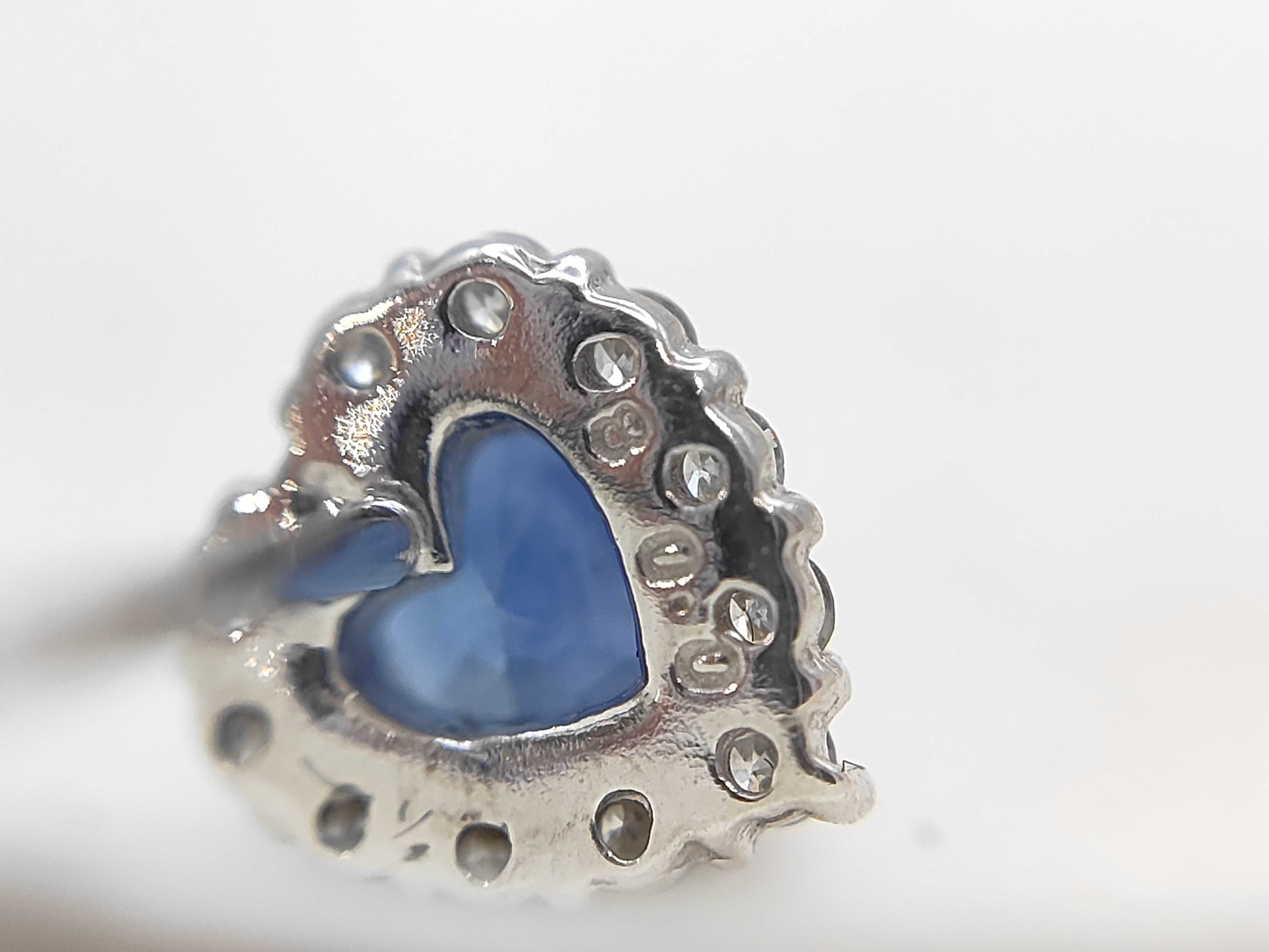 A Pair of 18 Karat White Gold Heart-Cut Sapphire and Diamond Halo Stud Earrings