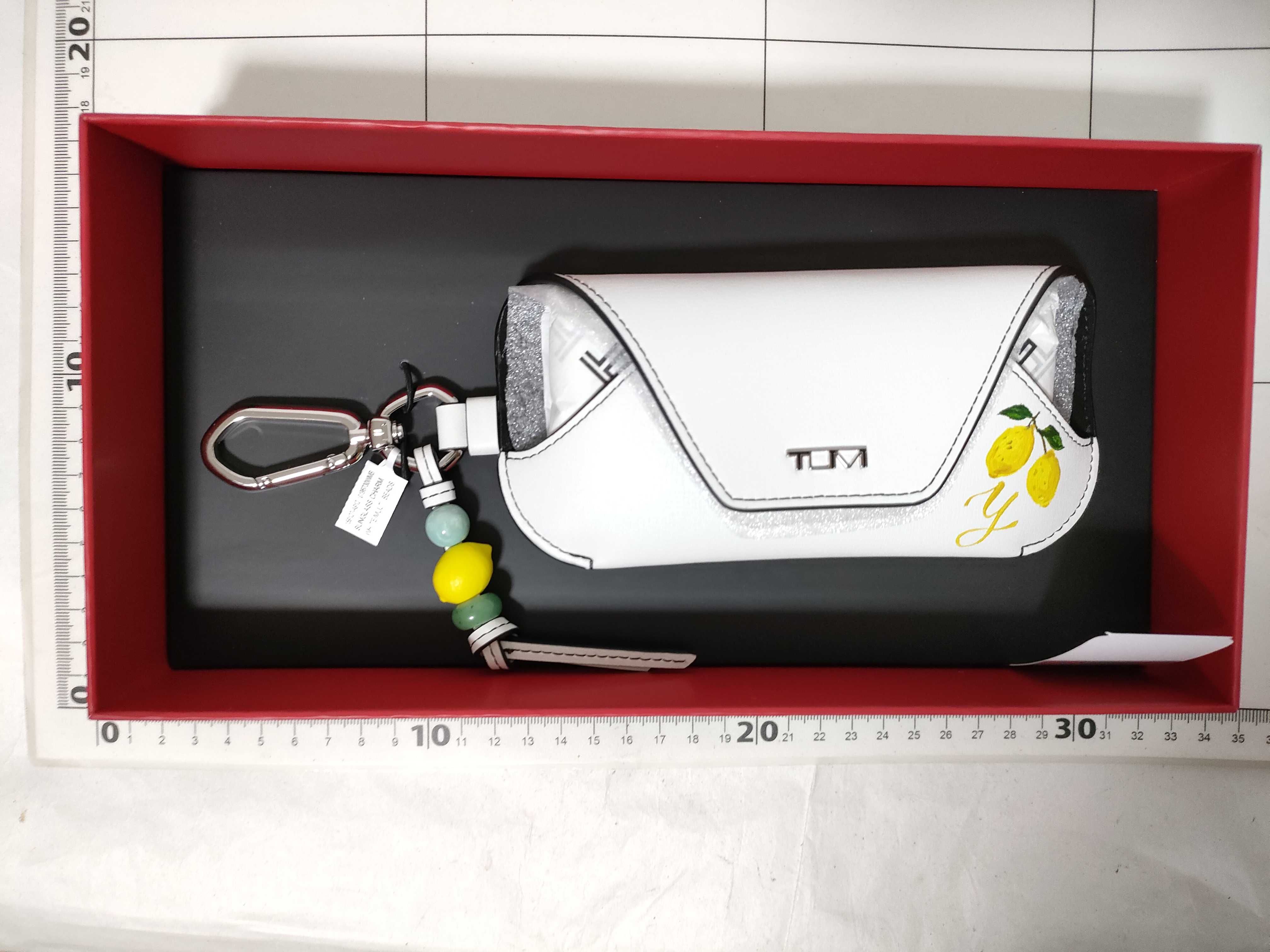 Tumi Belden White Leather Sunglass Case Charm with Lemon Motif