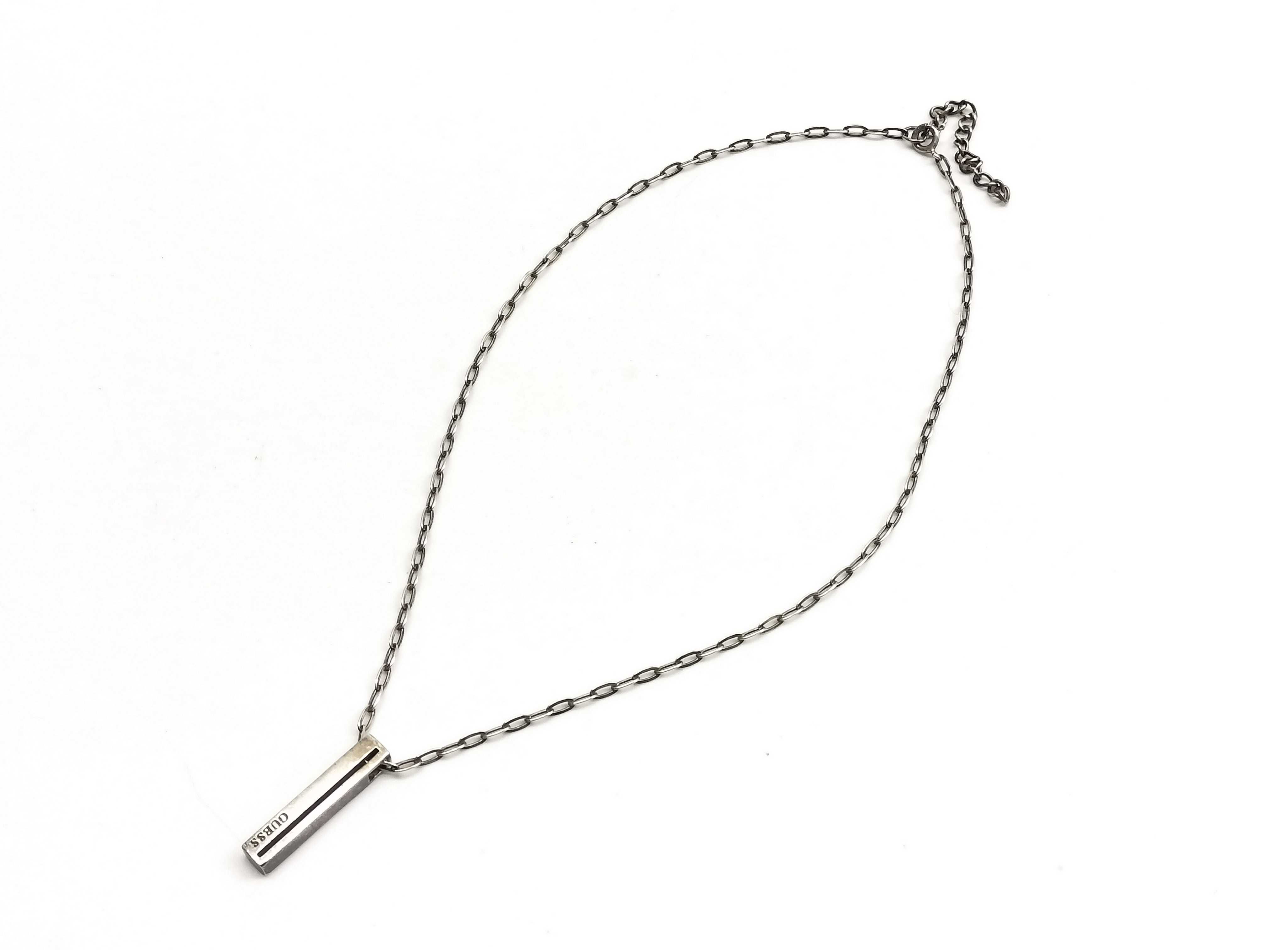 Two Pieces of Sterling Silver and Silver-Toned Jewelry Including a Guess Pendant Necklace and an Opal Inlay Ring