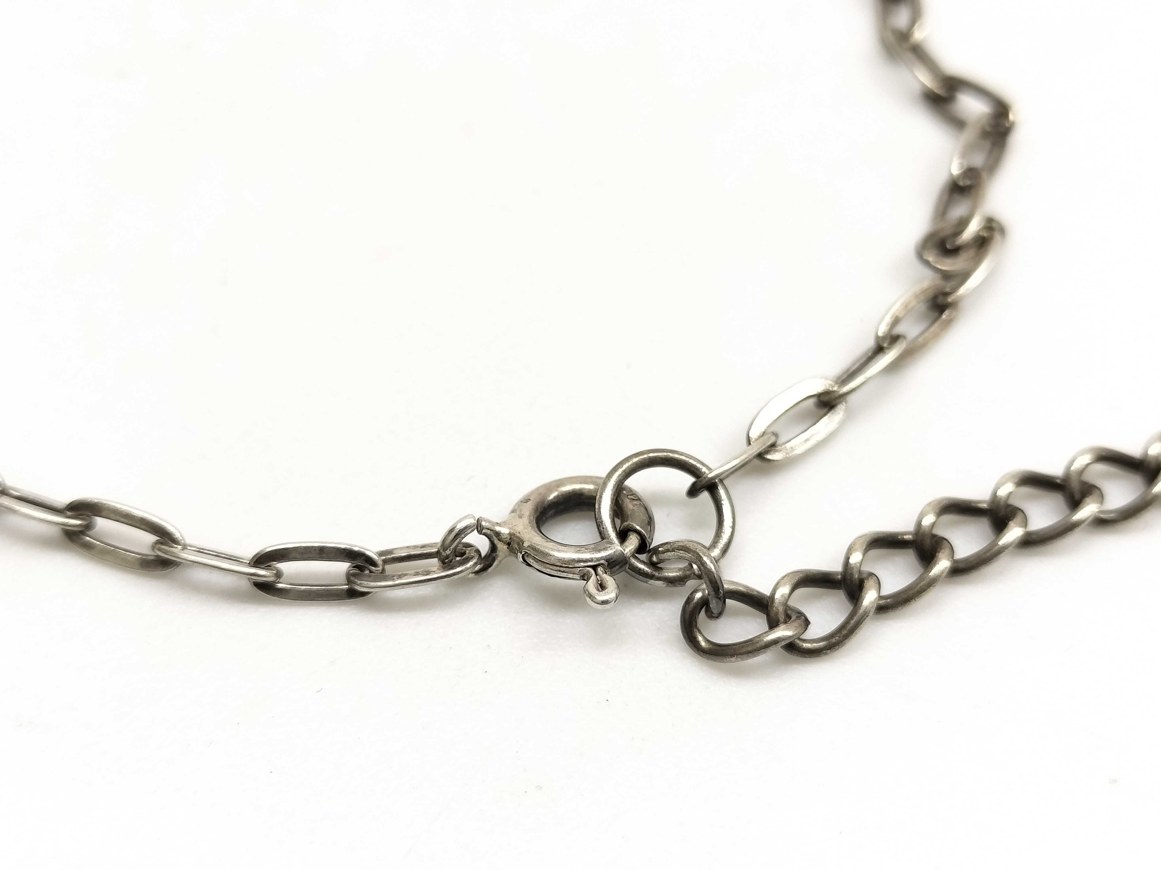 Two Pieces of Sterling Silver and Silver-Toned Jewelry Including a Guess Pendant Necklace and an Opal Inlay Ring