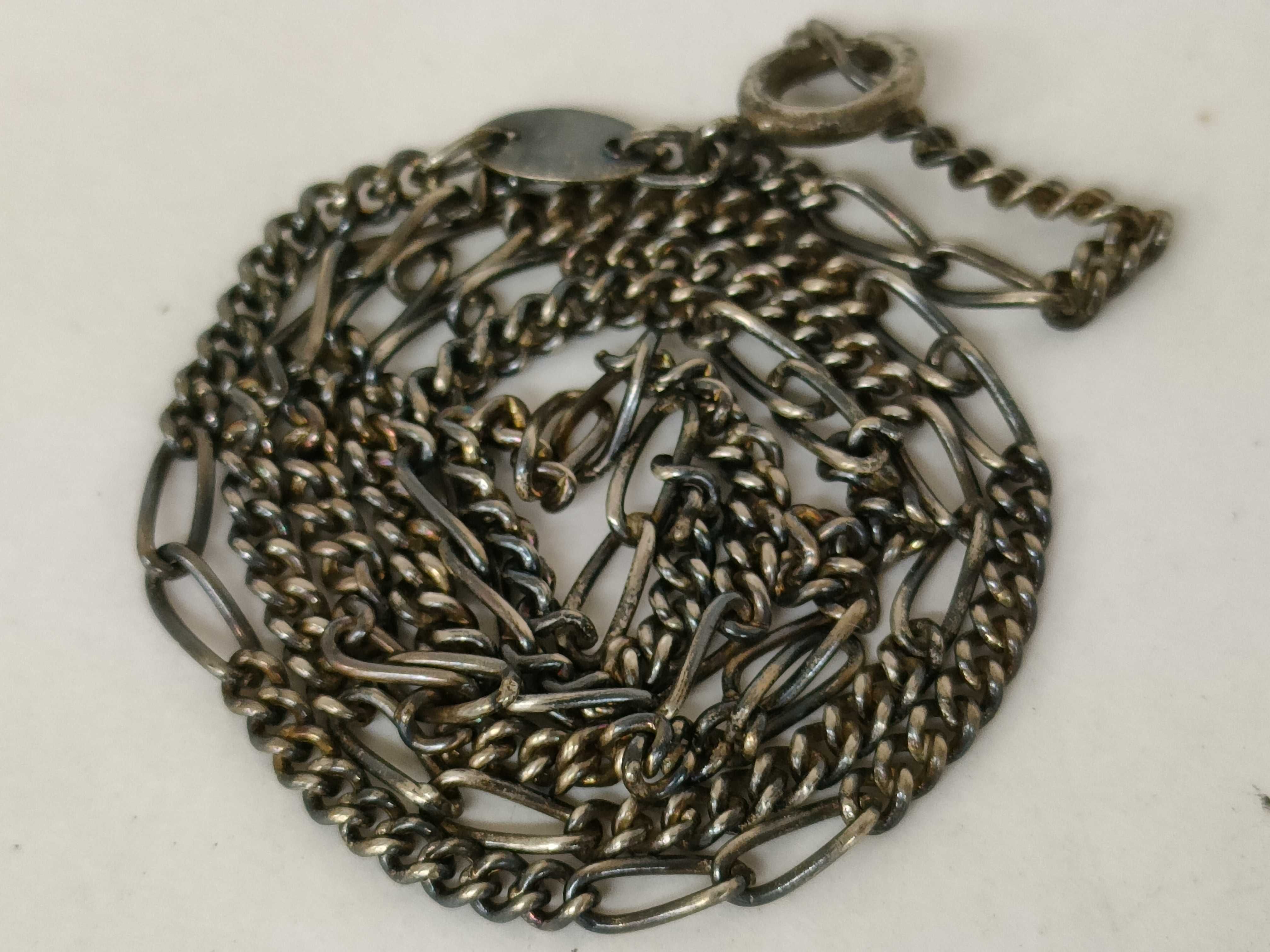 A Trio of Silver and Silver-Tone Jewelry Including a Figaro Chain, Teardrop Pendant, and Figural Bird Ring