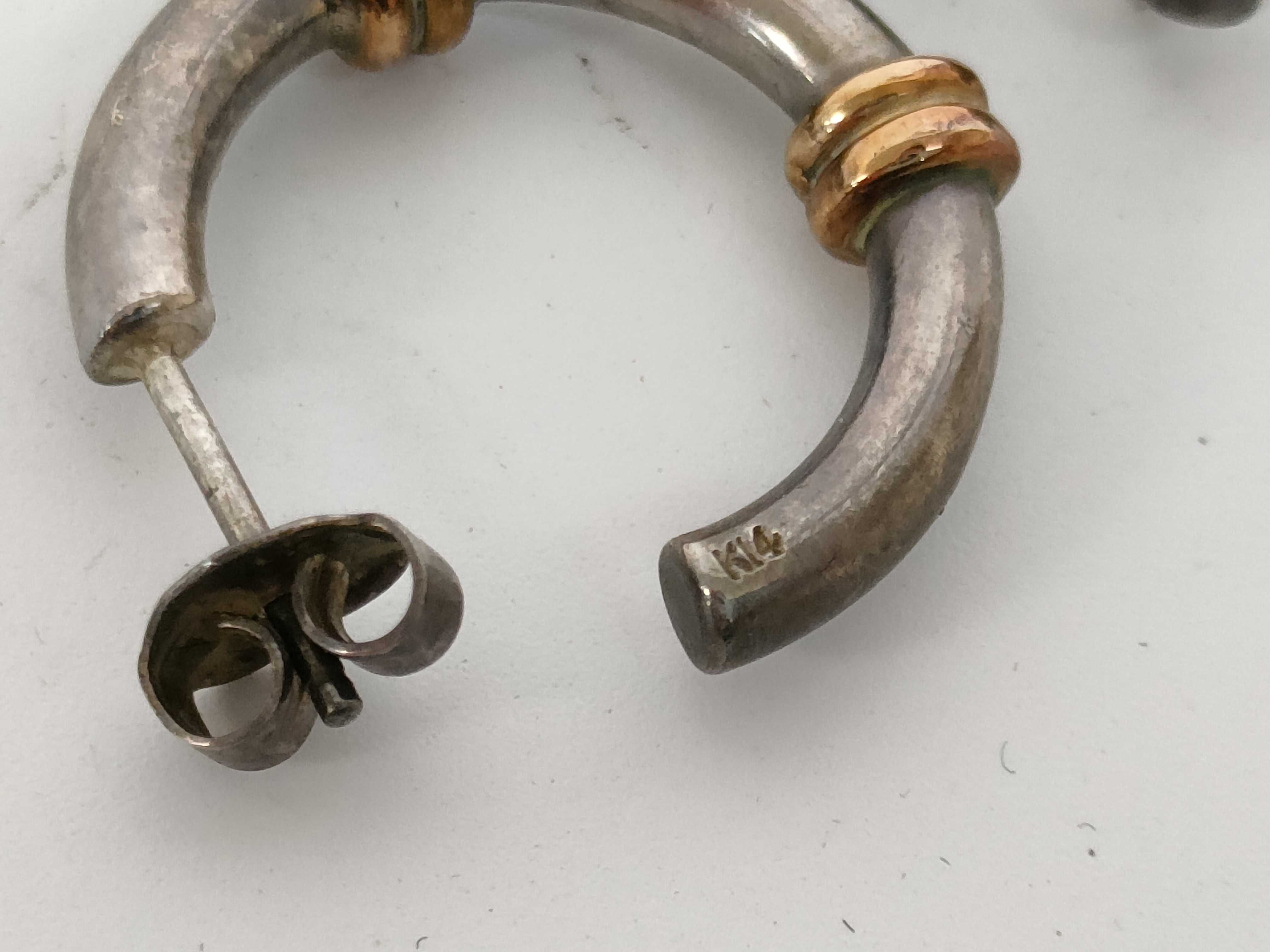 A Pair of Sterling Silver and 14 Karat Gold Two-Tone Hoop Earrings
