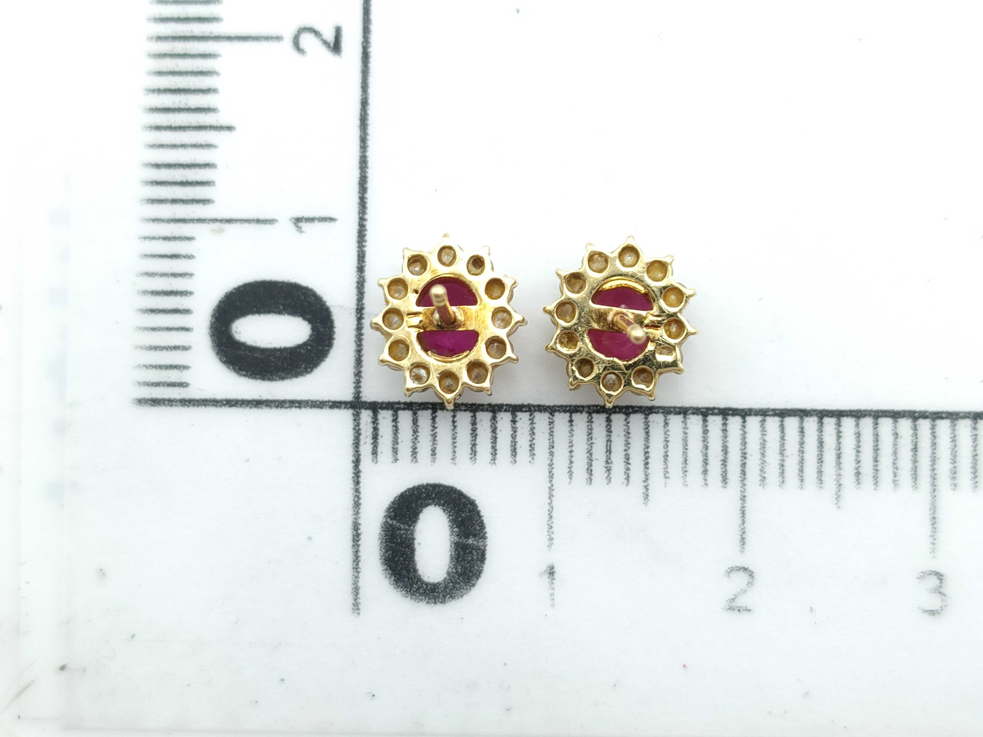 A Pair of 18K Yellow Gold Ruby and Diamond Halo Stud Earrings