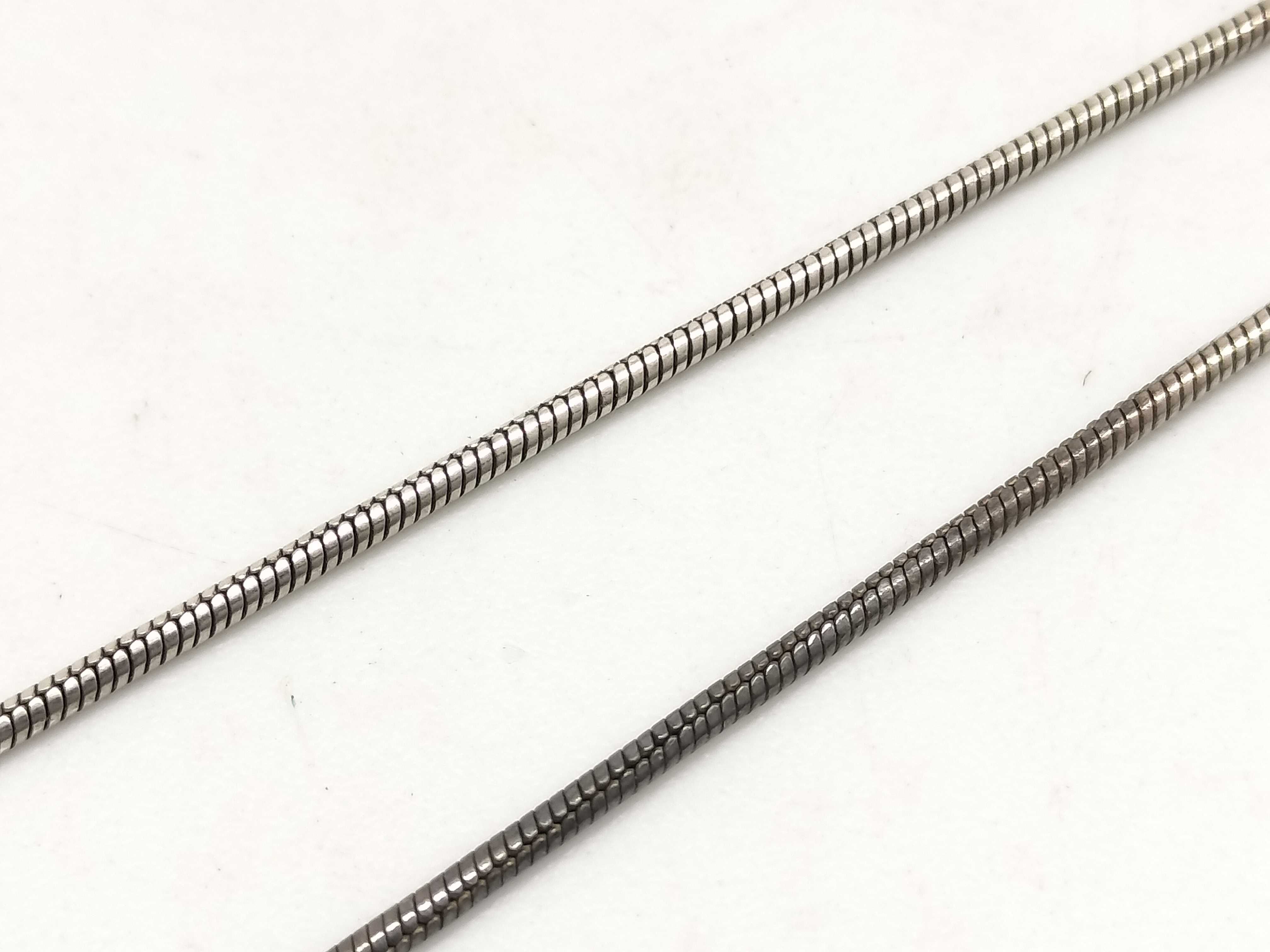 Two Sterling Silver Jewelry Items Including a Snake Chain Necklace and Artisan Band Ring