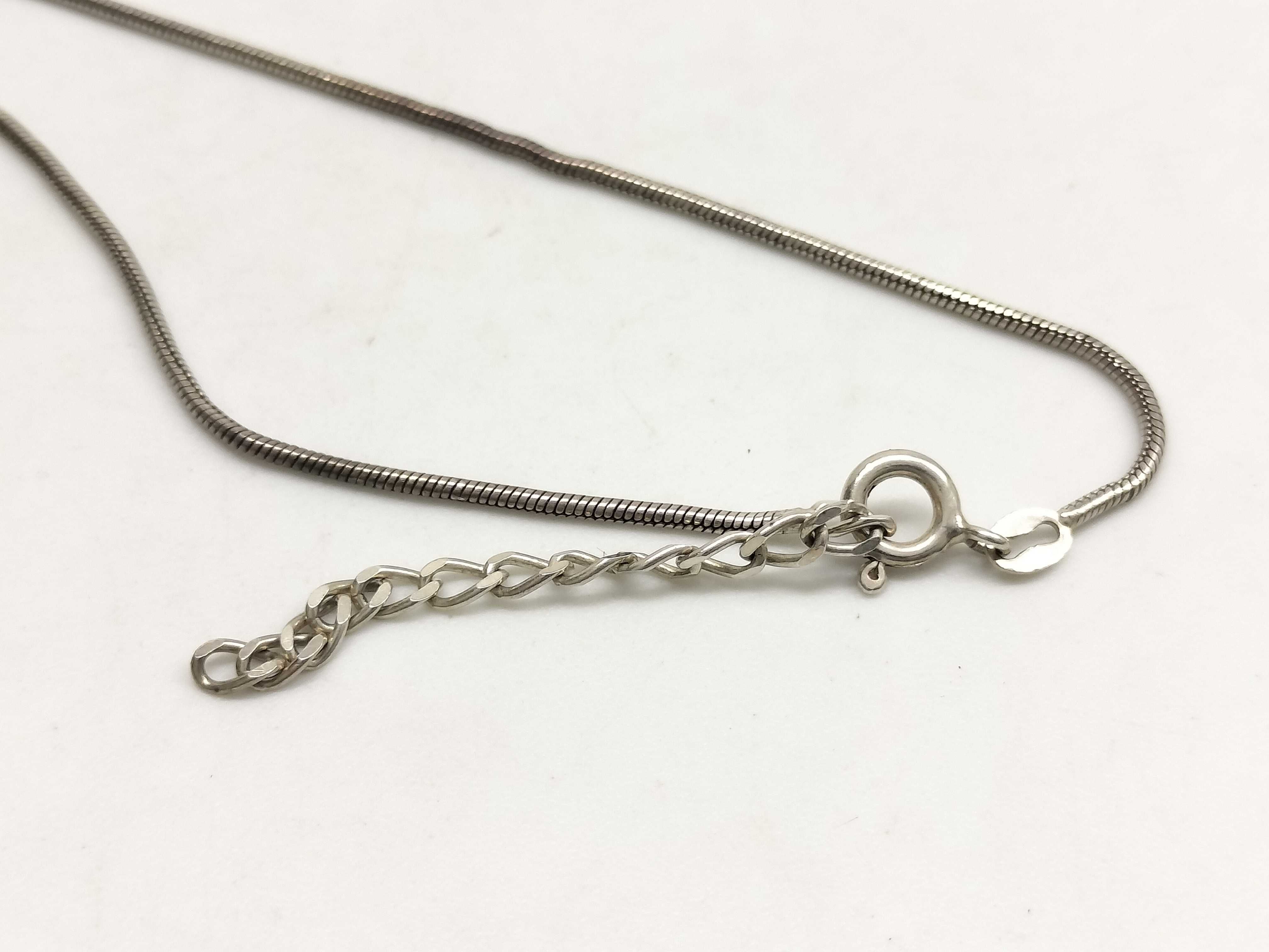Two Sterling Silver Jewelry Items Including a Snake Chain Necklace and Artisan Band Ring