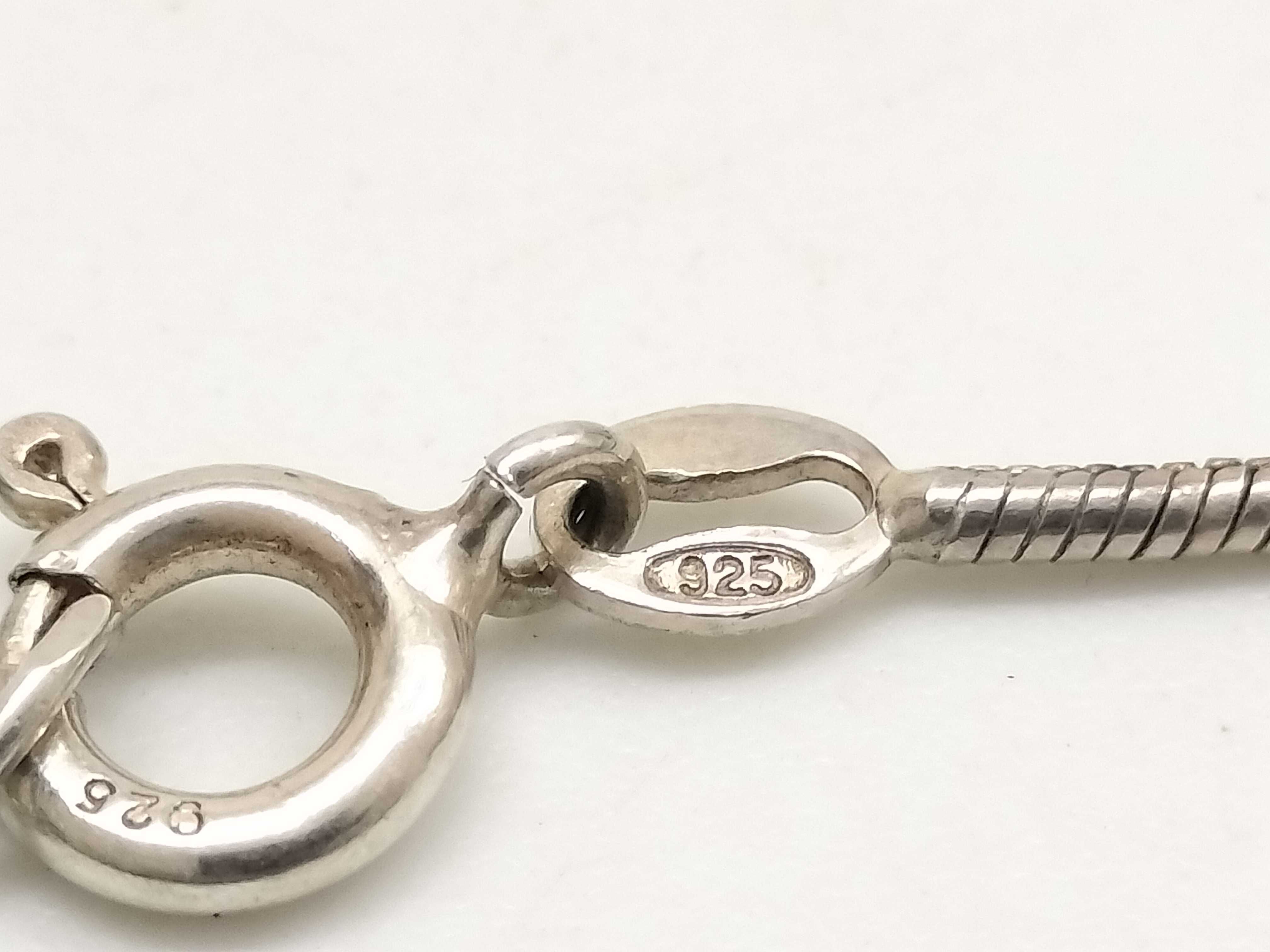 Two Sterling Silver Jewelry Items Including a Snake Chain Necklace and Artisan Band Ring