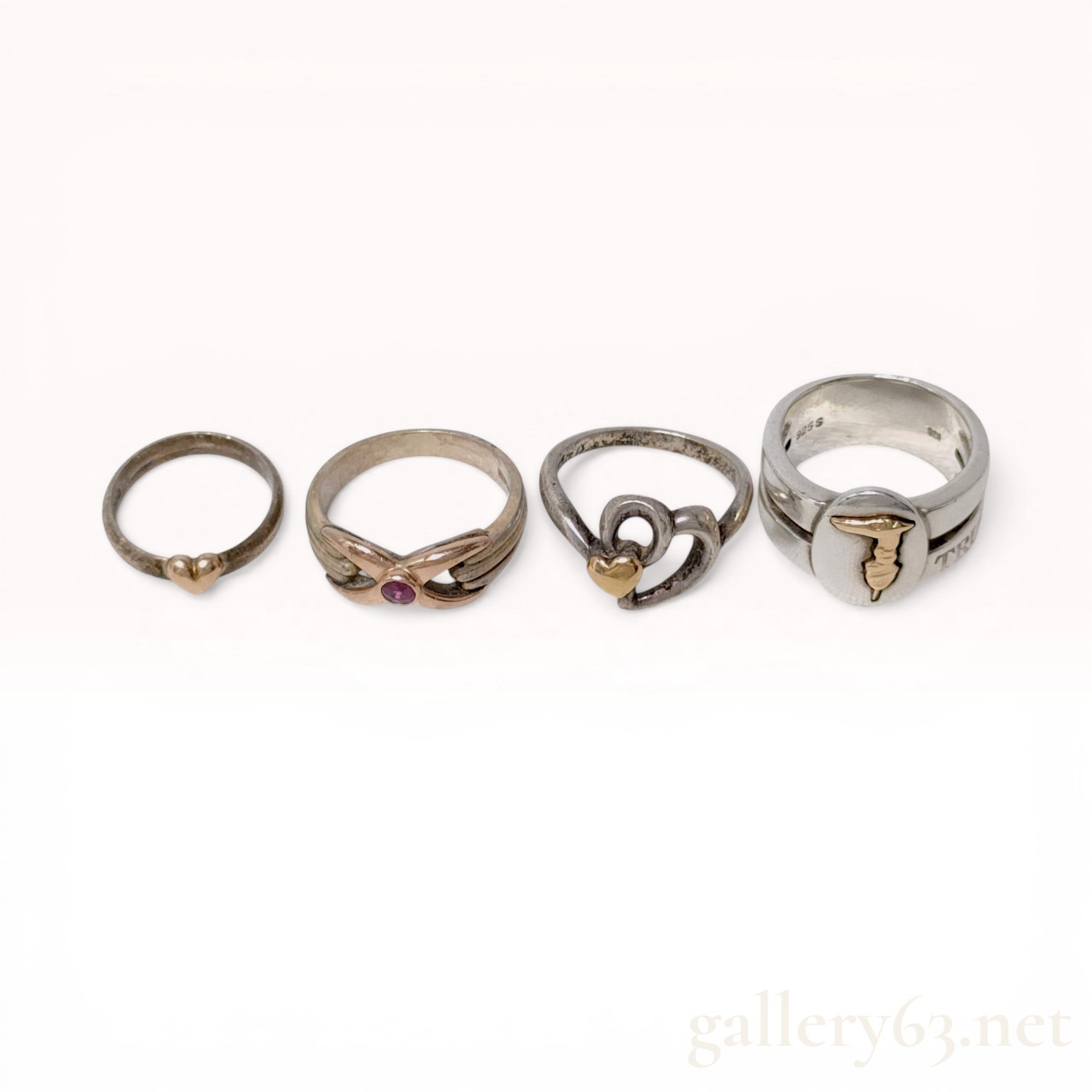 Four Mixed Karat Gold and Sterling Silver Rings