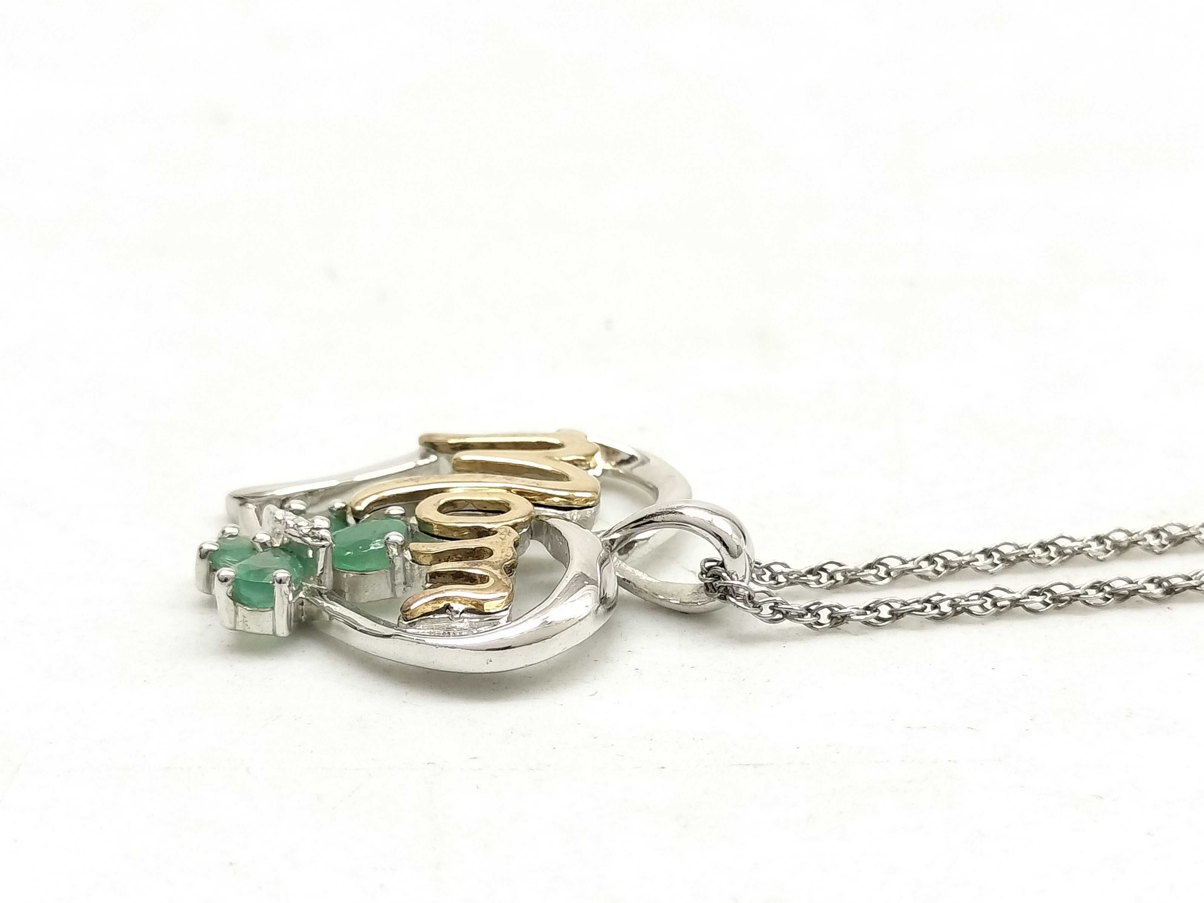 Two Pieces of Sterling Silver Jewelry Including an ete Bypass Ring and a 14K Gold Accent Mom Pendant Necklace