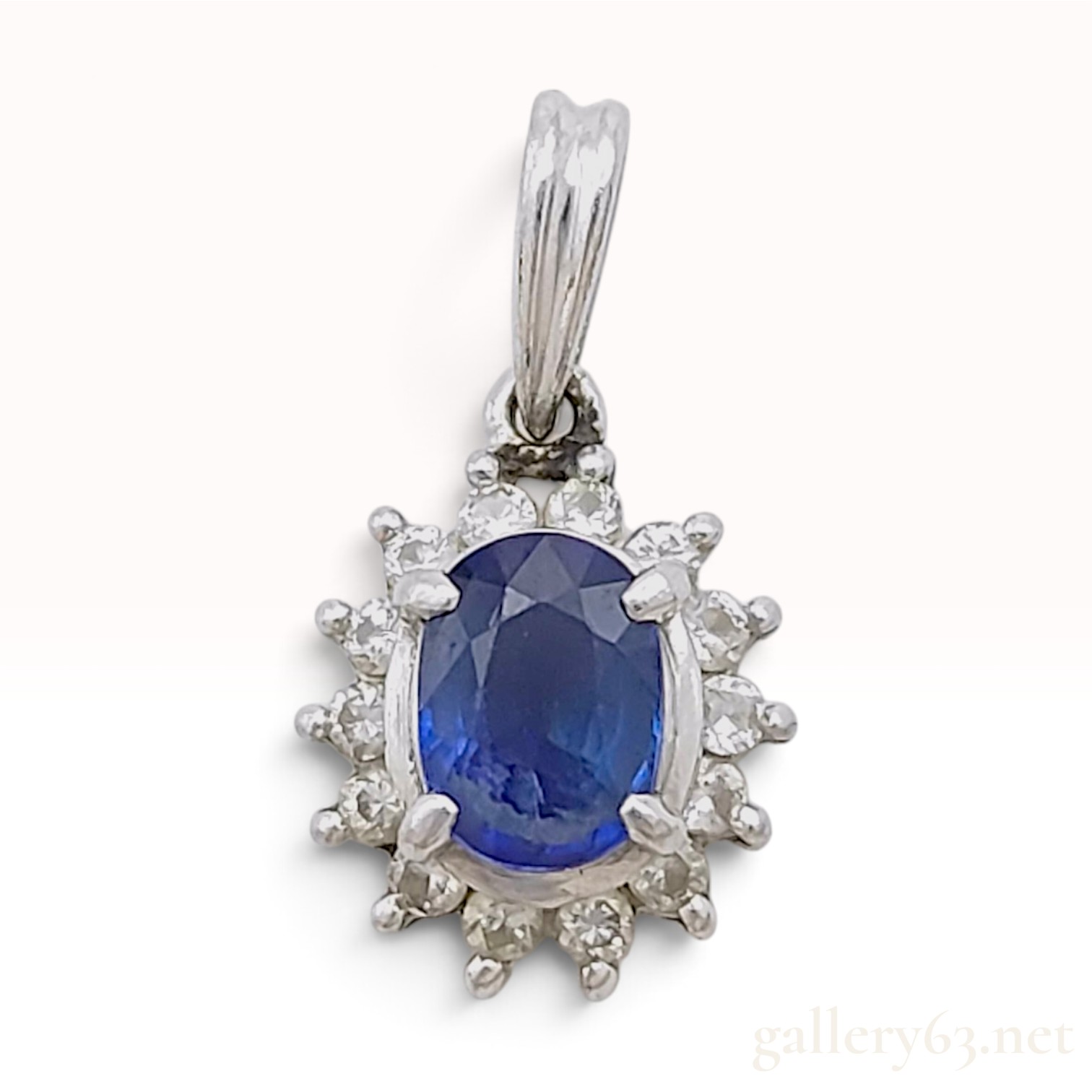 Platinum Blue Sapphire and Diamond Halo Pendant, S0.63ct D0.16ct