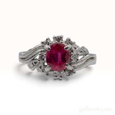 A Vintage Platinum 0.62ct Ruby and 0.21ctw Natural Diamond Cocktail Ring. This Platinum cocktail 