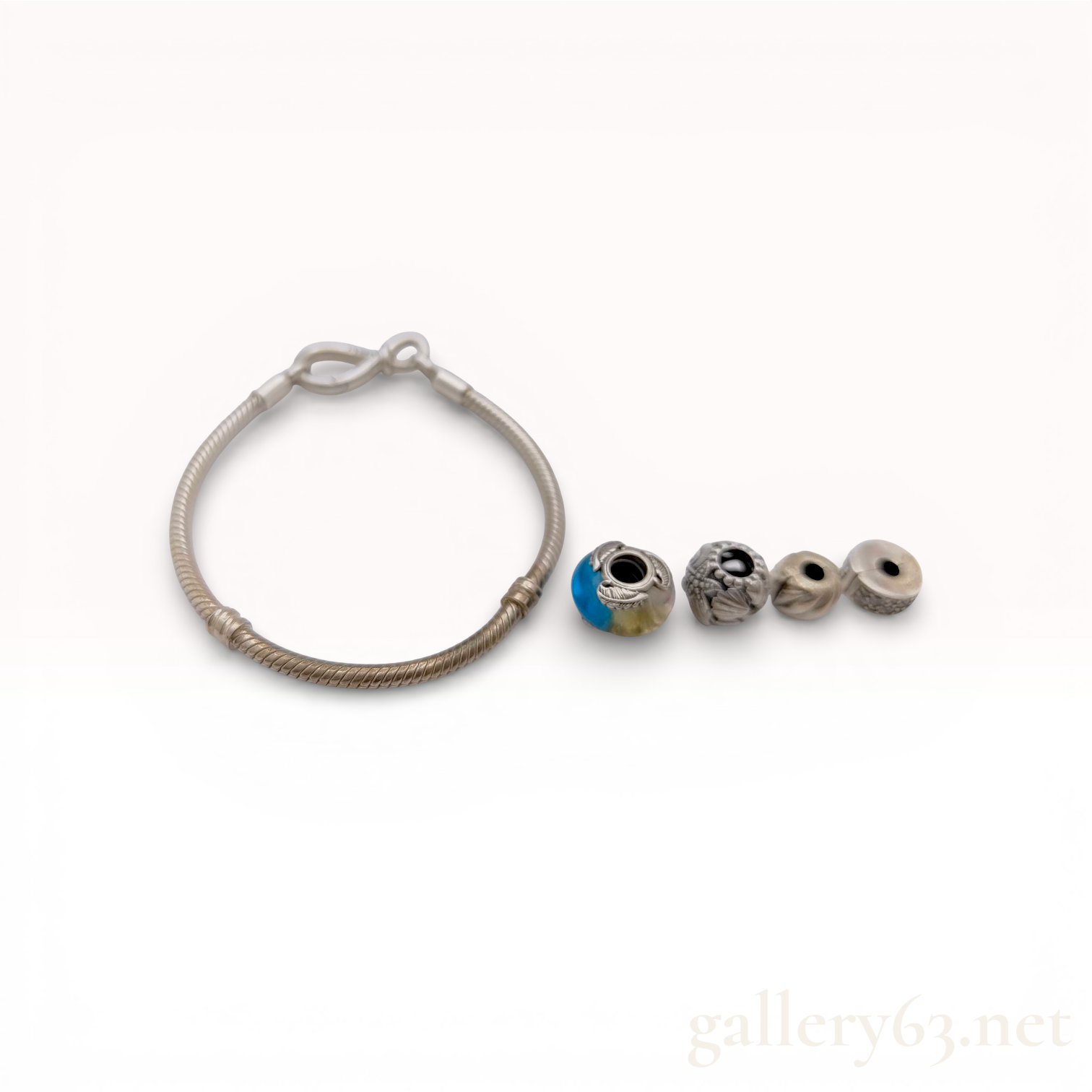 Pandora Sterling Silver Snake Chain Bracelet with Infinity Knot Clasp, Four Charms, and Box