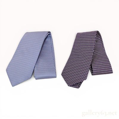 Two Hermes Silk Geometric and Striped Neckties. Hermes silk neckties featuring one light blue 