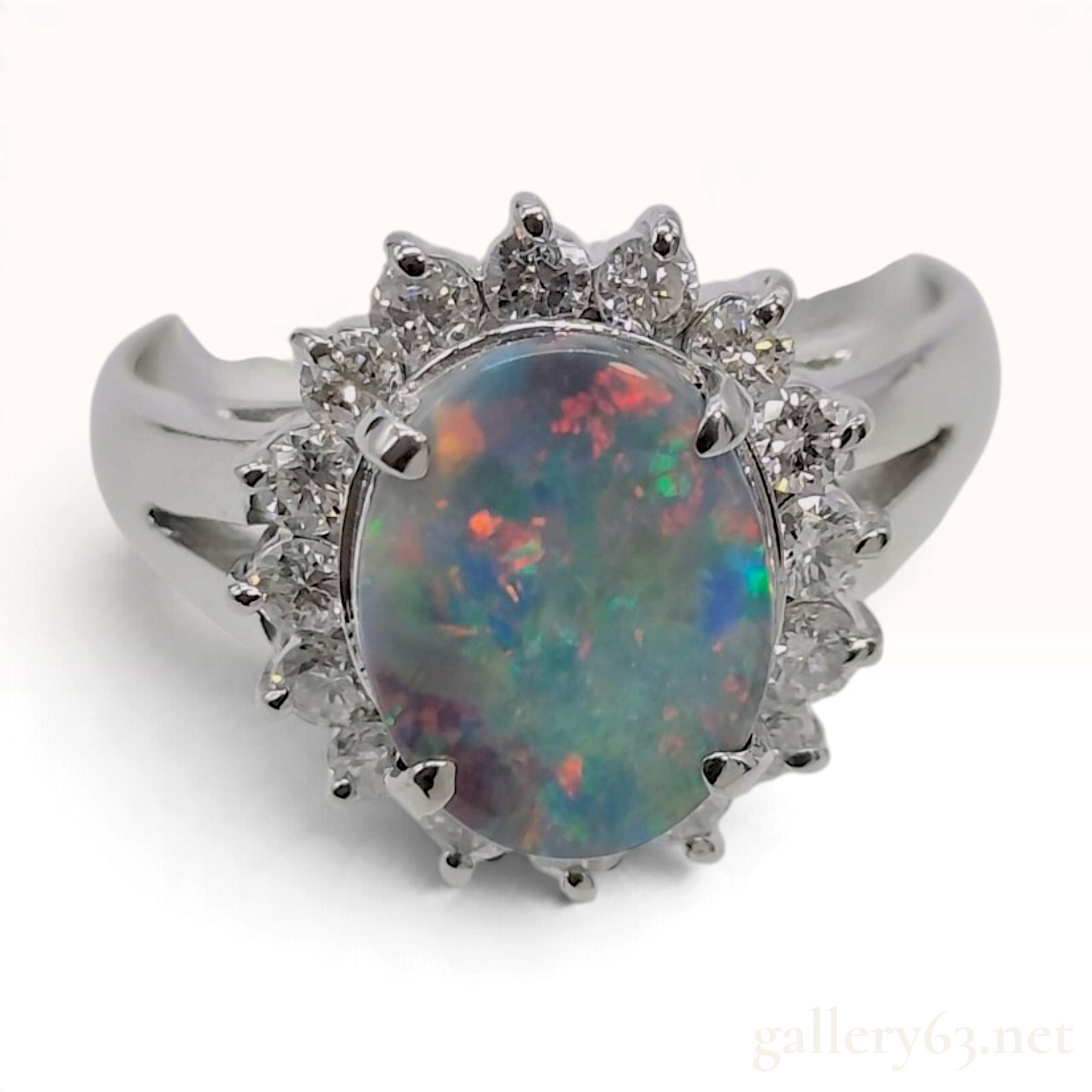 A Platinum Opal and Diamond Halo Cocktail Ring, size 6.25