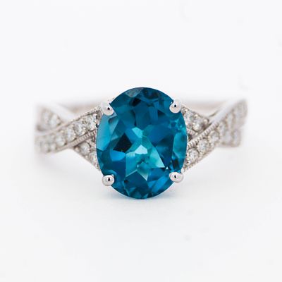 14K WG Blue Topaz & Diamond Ring, size 7. 14k white gold having a deep blue 10x 8 mm London 