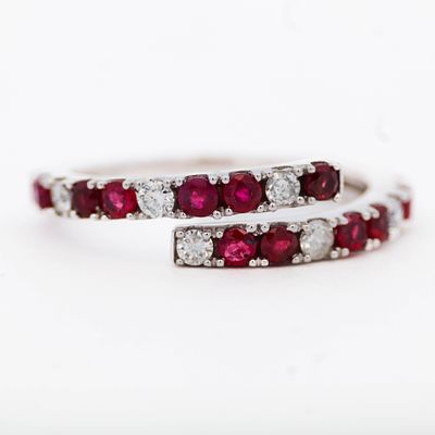 14K WG Ruby & Diamond Ring, size 7. 14k white gold bypass ring having .72ctw round cut rubies 