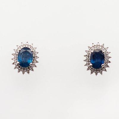14K WG Sapphire & Diamond Halo Earrings. 14k white gold stud earrings featuring oval blue 