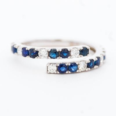 14K WG Sapphire & Diamond Ring, size 7. 14k white gold bypass ring having .72ctw round cut 