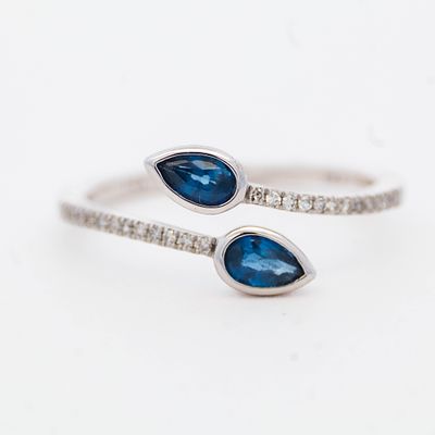 14K WG Sapphire & Diamond Ring. 14K white gold bypass with two pear-shaped sapphires facing each 